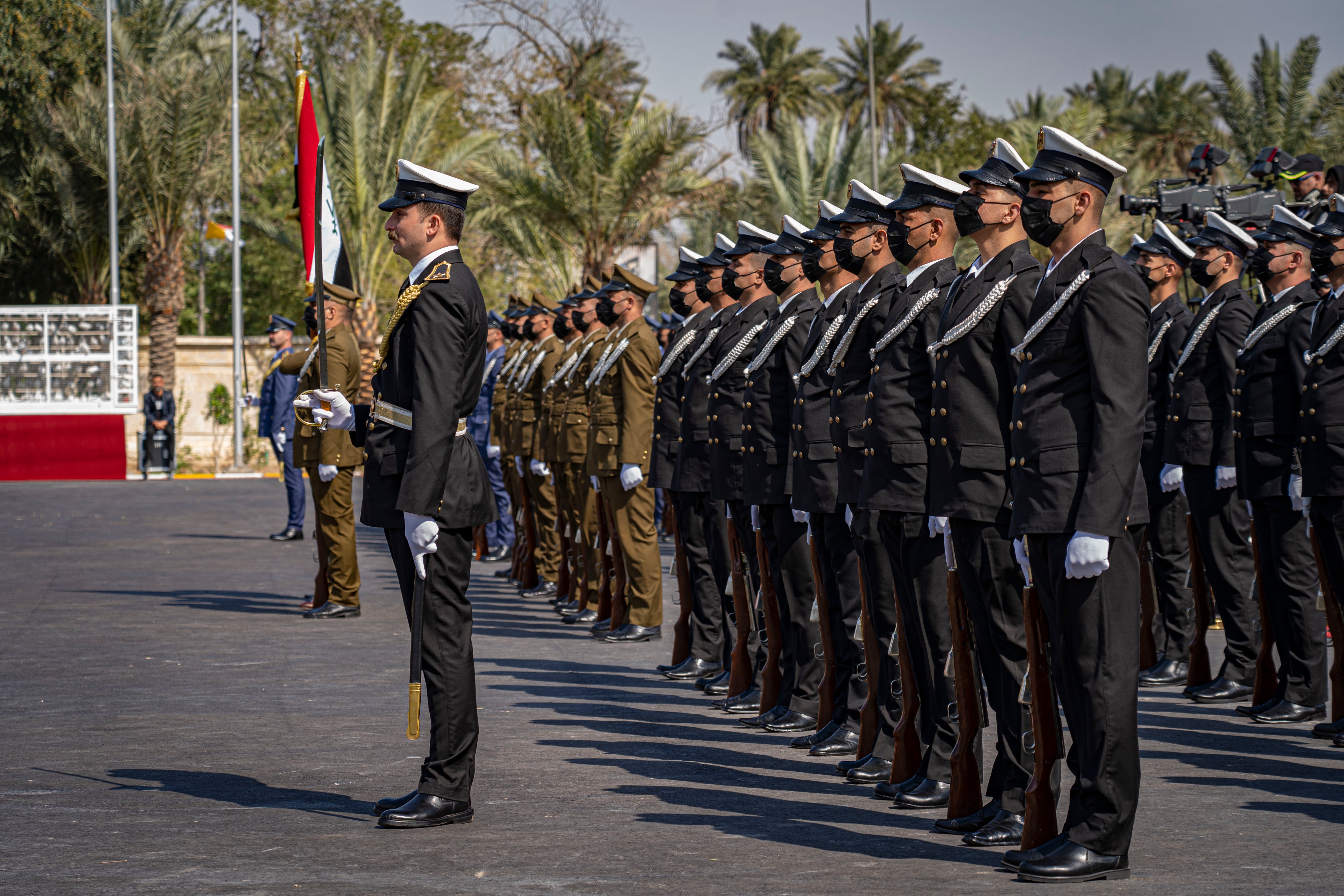 Guards at the presidential palace greet Pope Francis on his first visit to Iraq