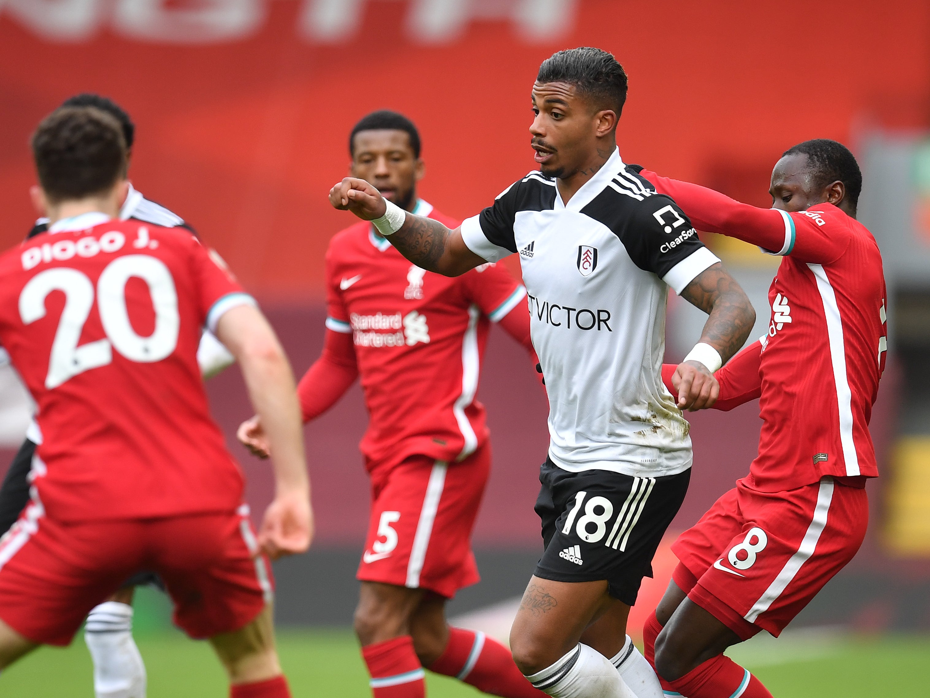 Fulham goalscorer Mario Lemina is surrounded by Liverpool players