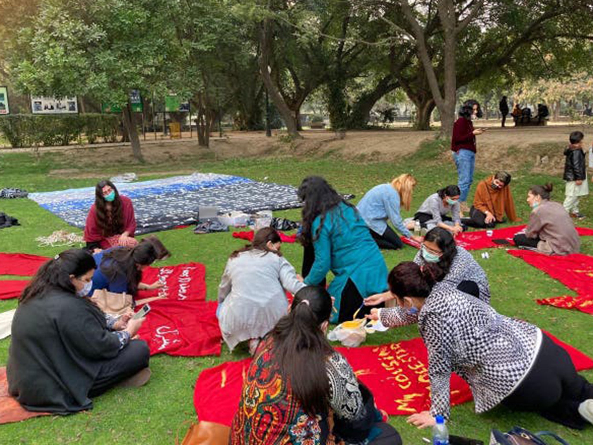 Women painting the messages in Lahore