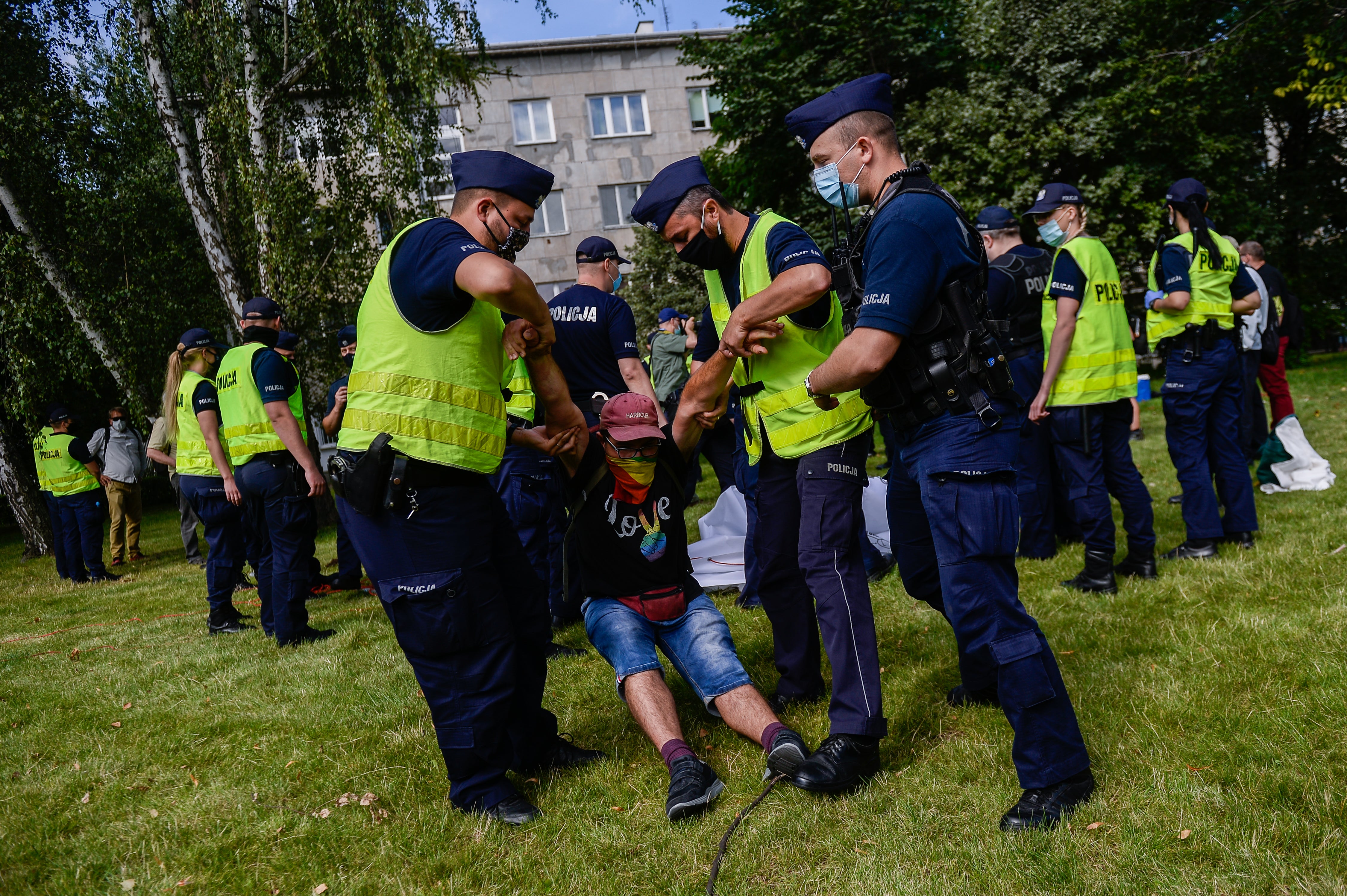 Police remove a protester wearing a shirt saying ‘love’ with rainbow colours as he protests during the swearing-in ceremony for President Andrzej Duda