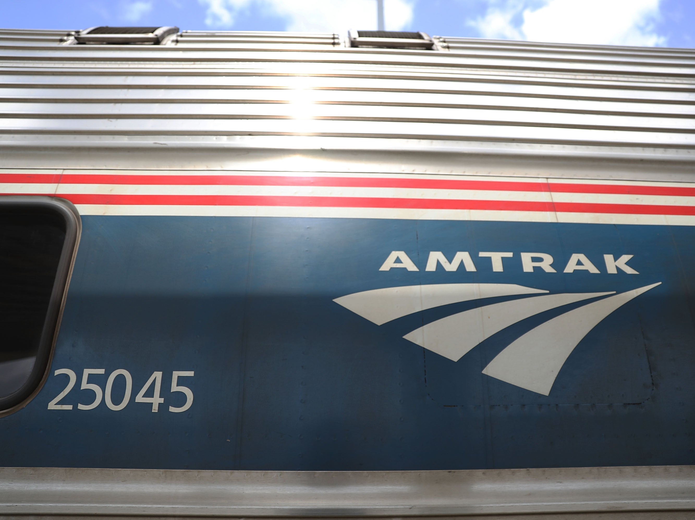 An Amtrak train is seen as people board at the Miami station on 24 May, 2017 in Miami, Florida