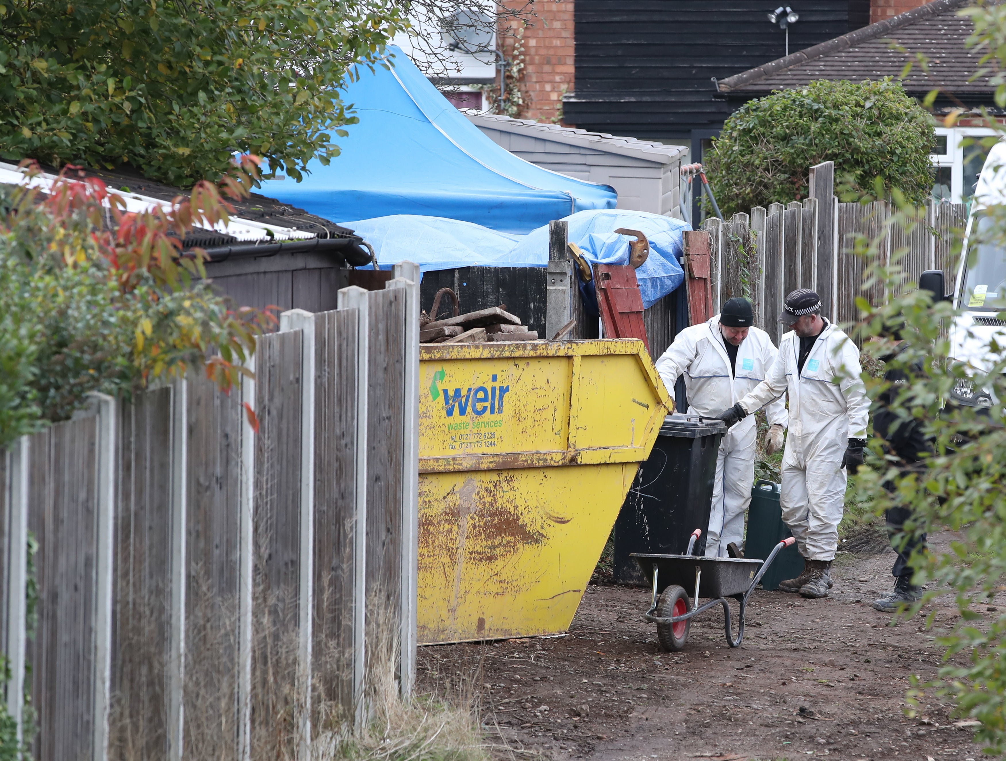 A forensics team in the back garden of a property on Shipton Road in Sutton Coldfield, where police began a search for the body of Suzy Lamplugh