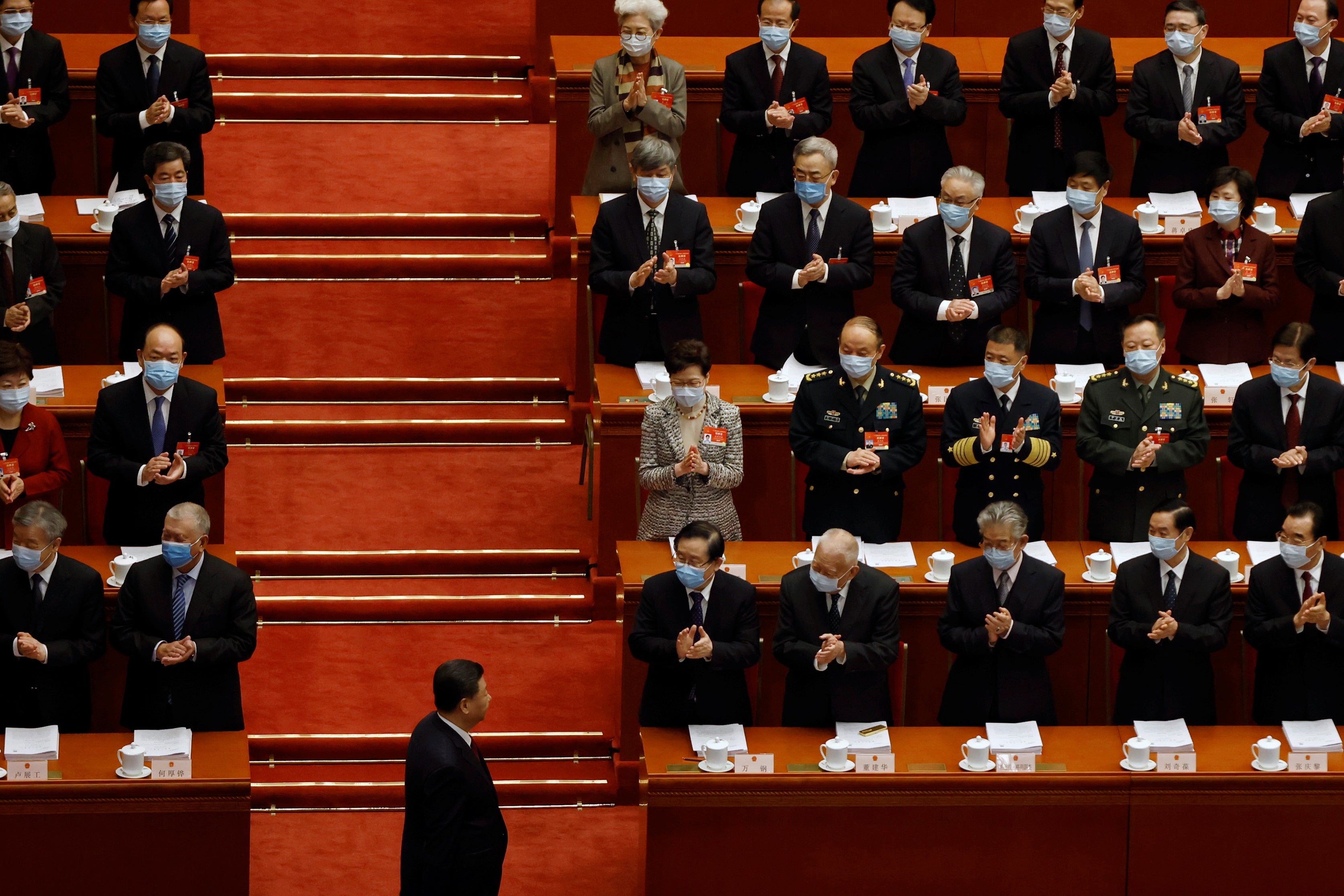 Hong Kong chief executive Carrie Lam joins others applauding Chinese President Xi Jinpin at the Great Hall of the People in Beijing