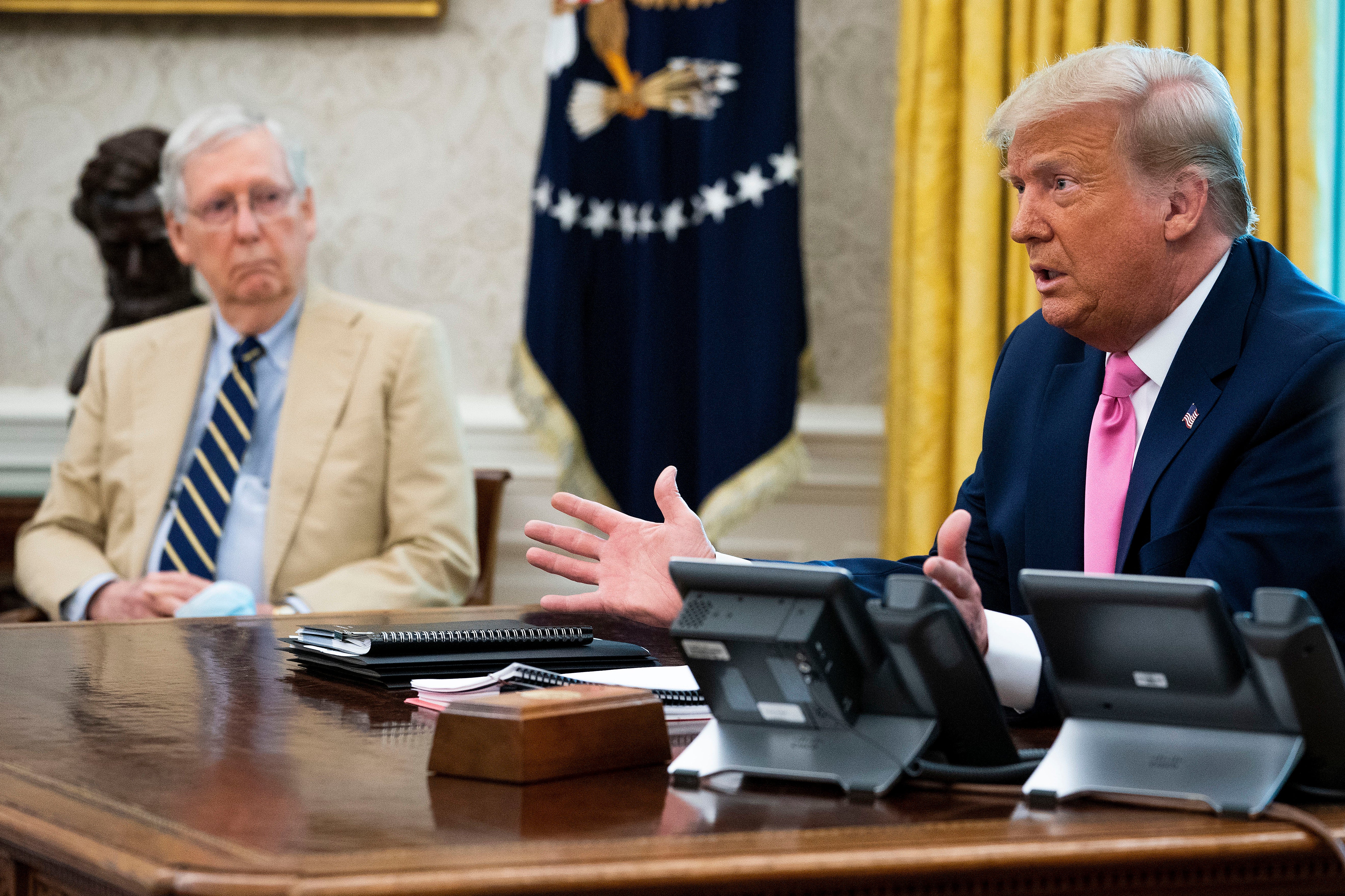 Senate Majority Leader Mitch McConnell (R-KY) (L) listens to U.S. President Donald Trump talks to reporters while hosting Republican congressional leaders and members of Trump's cabinet in the Oval Office at the White House July 20, 2020 in Washington, DC.