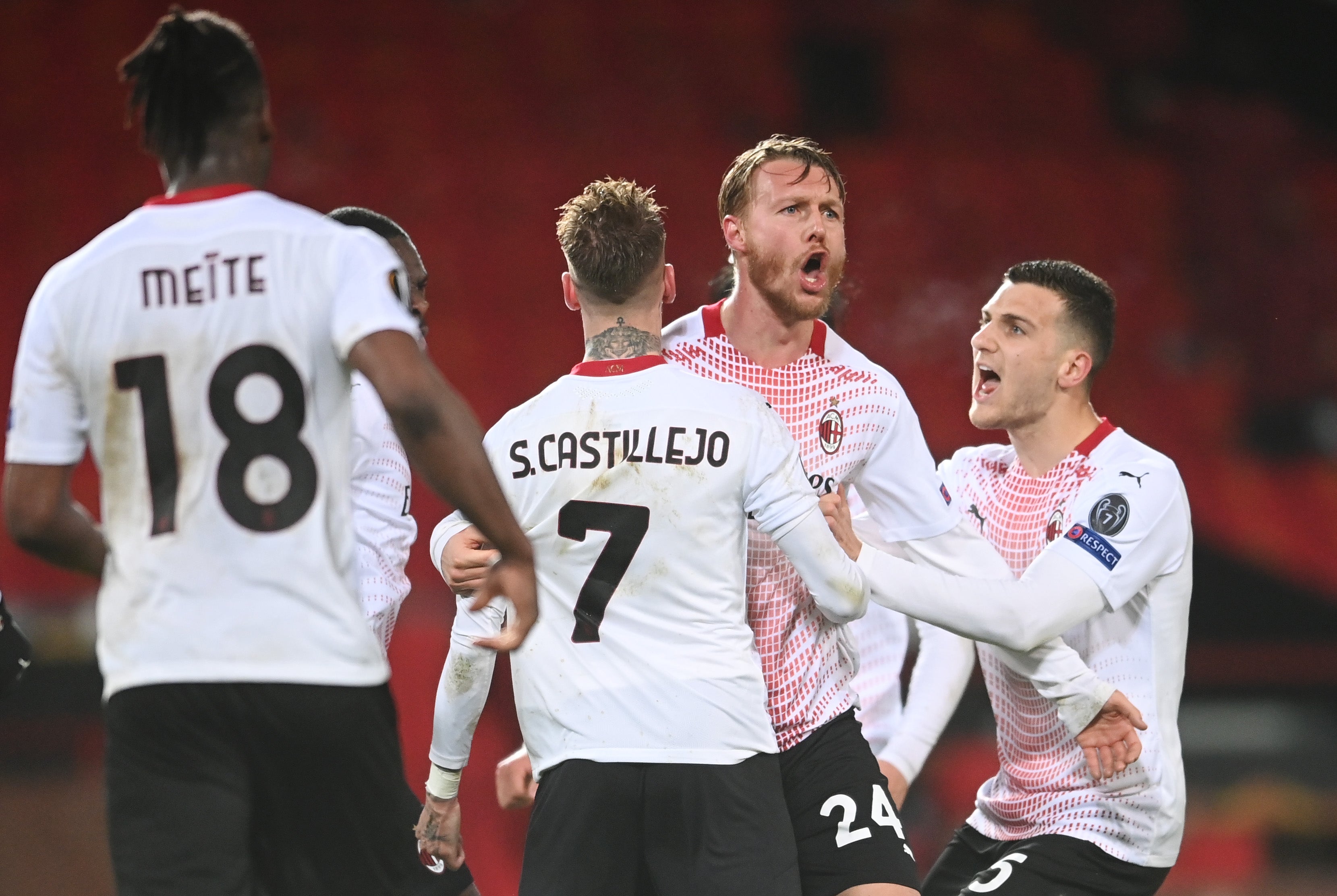 Simon Kjaer celebrates with teammates Samu Castillejo and Diogo Dalot