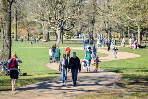 Wlkers in Bute Park, Cardiff in sunny weather