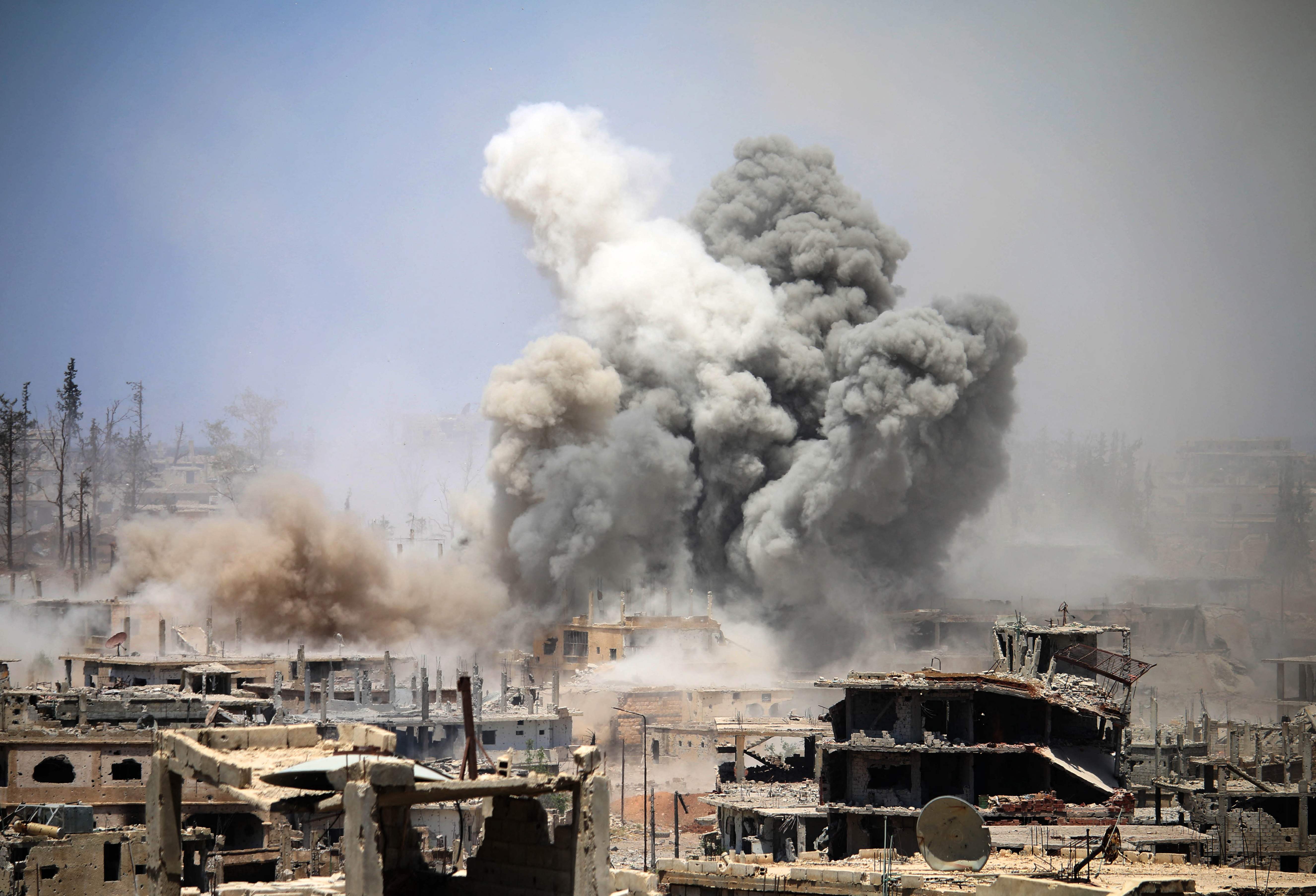 Smoke rises from buildings following an airstrike on a rebel-held area in the southern Syrian city of Daraa, in May 2017