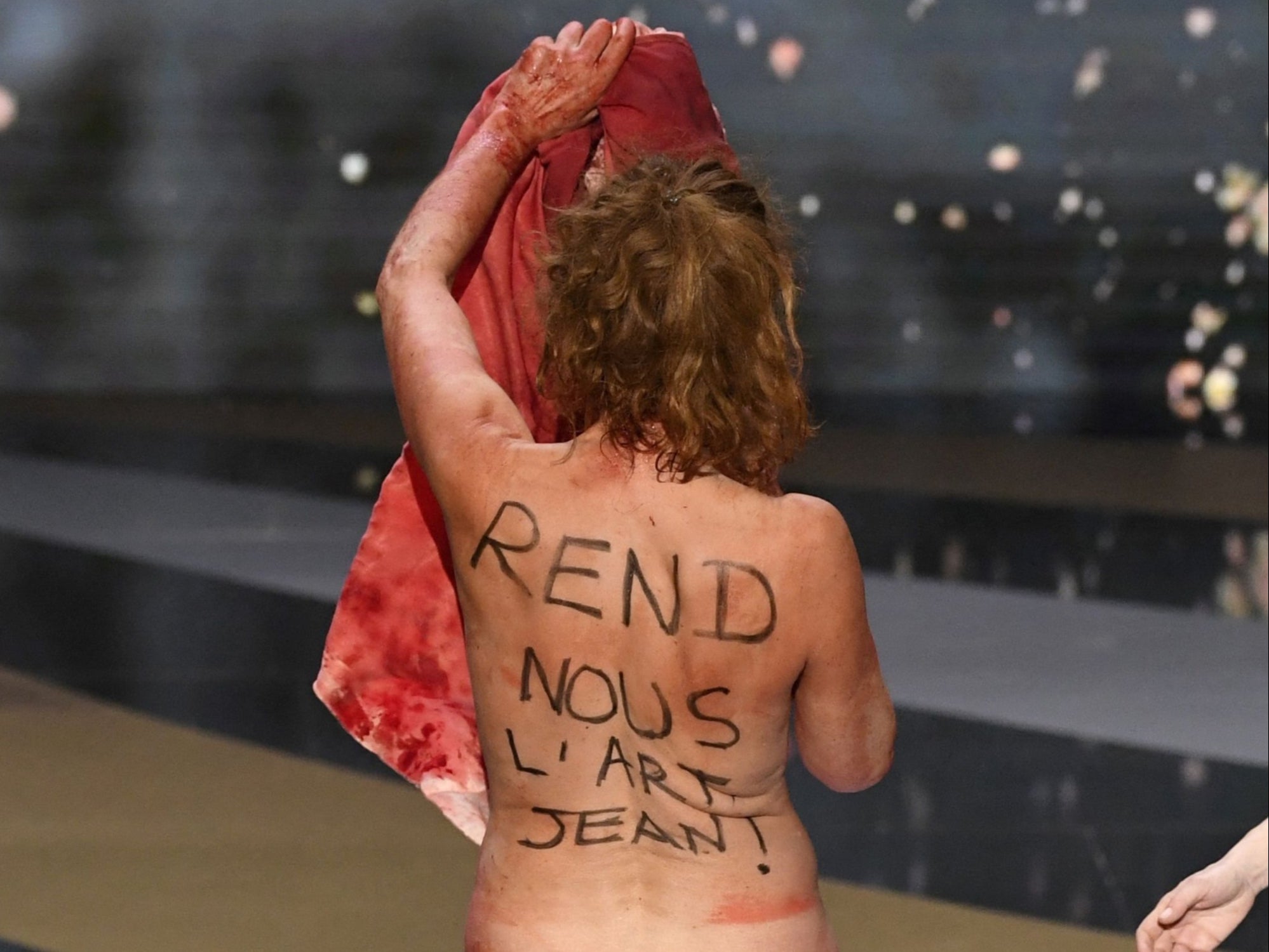 Masiero’s back reads: ‘Give us back our art, Jean,’ a direct plea to prime minister Jean Castex