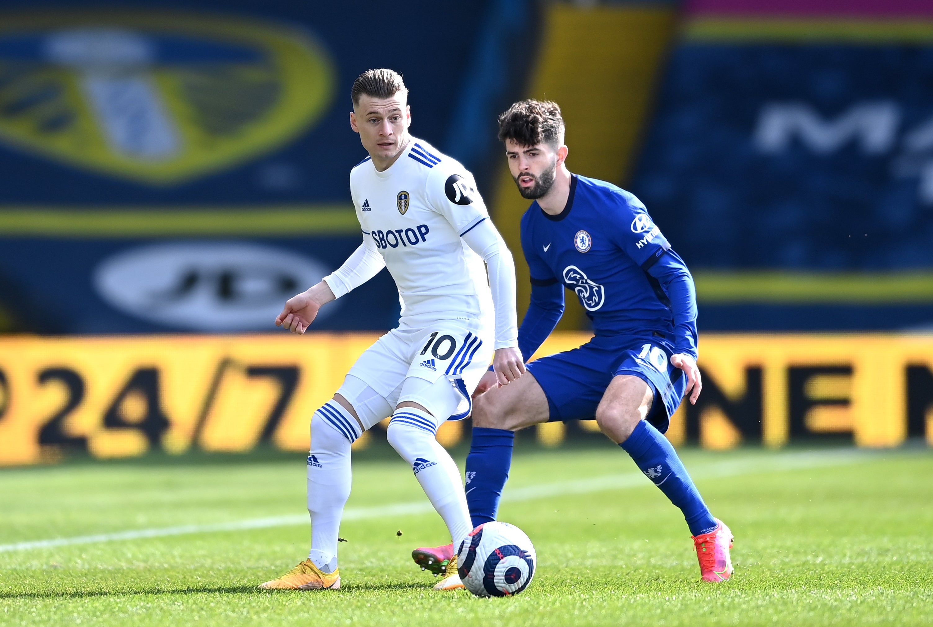 Ezgjan Alioski battles for possession with Christian Pulisic