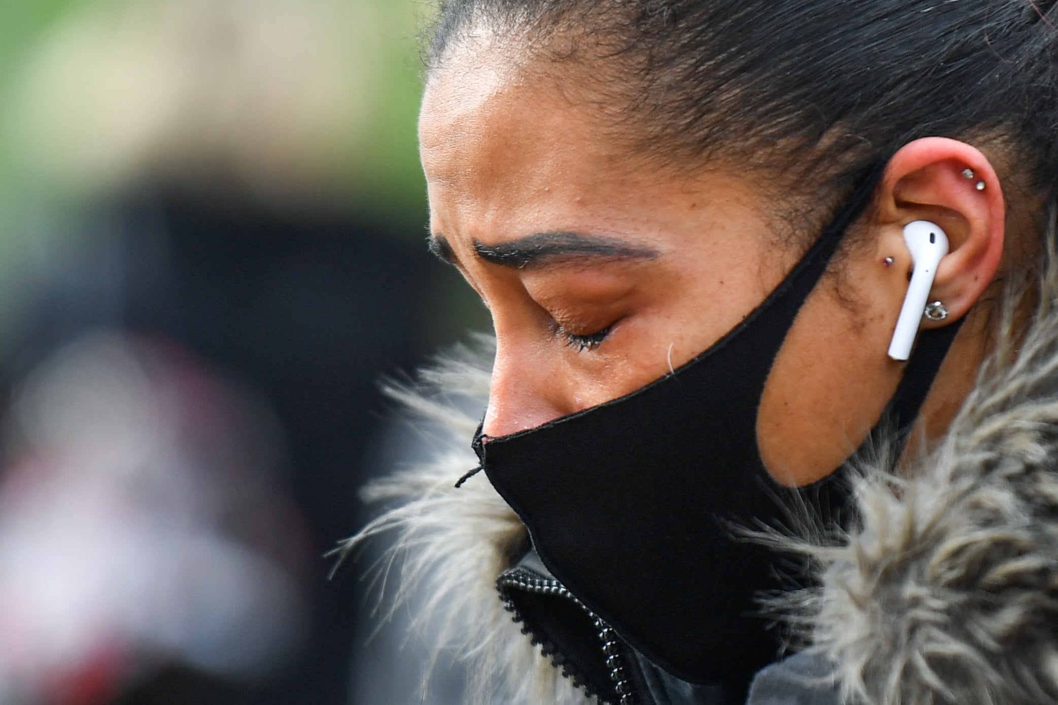 A woman cries at a memorial site at the Clapham Common Bandstand