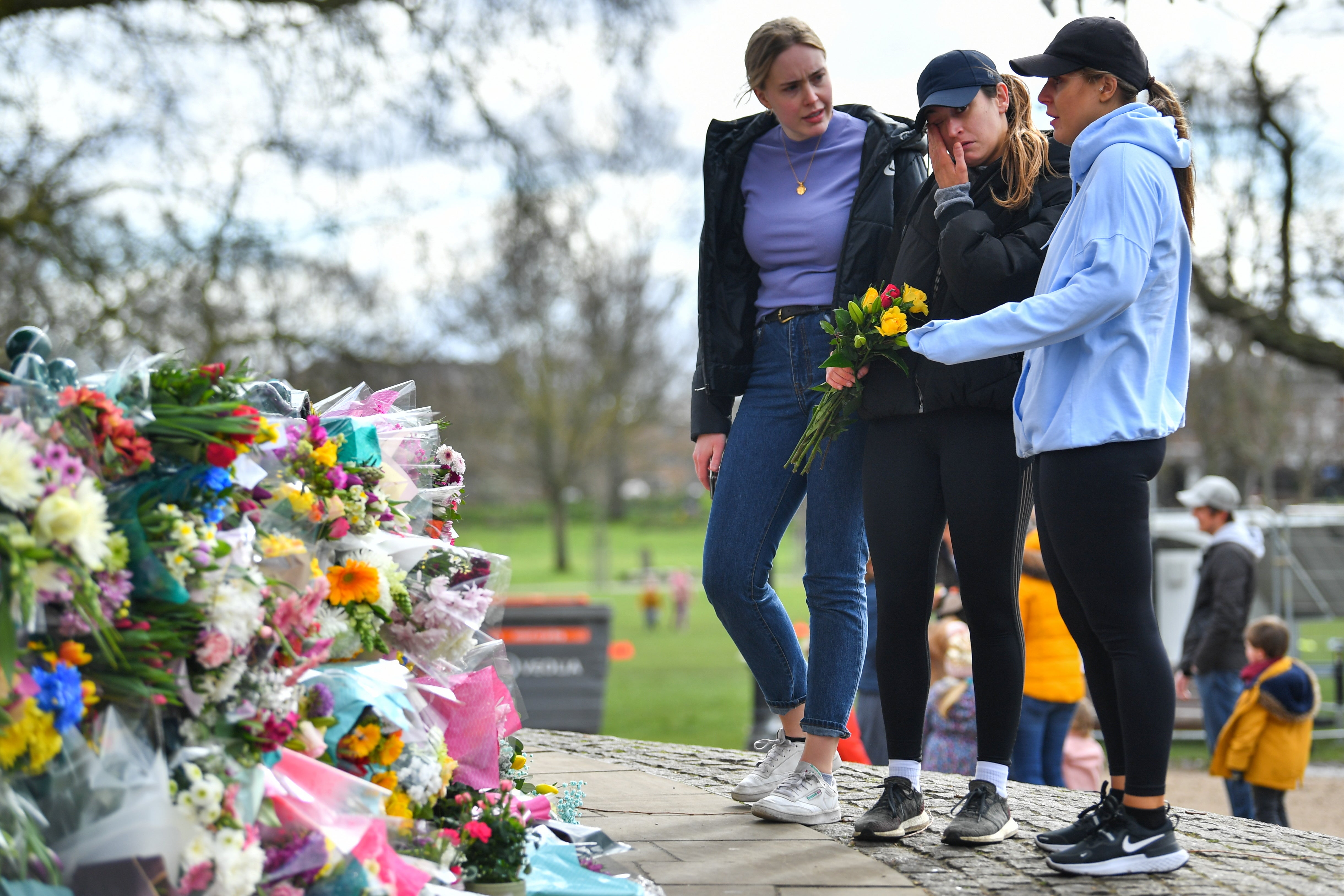 People mourn at a memorial site