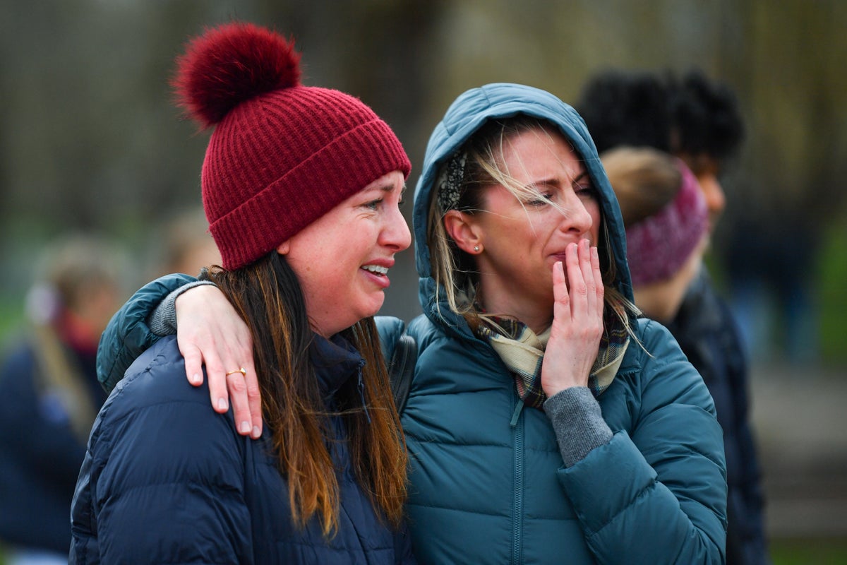People mourn at a memorial site