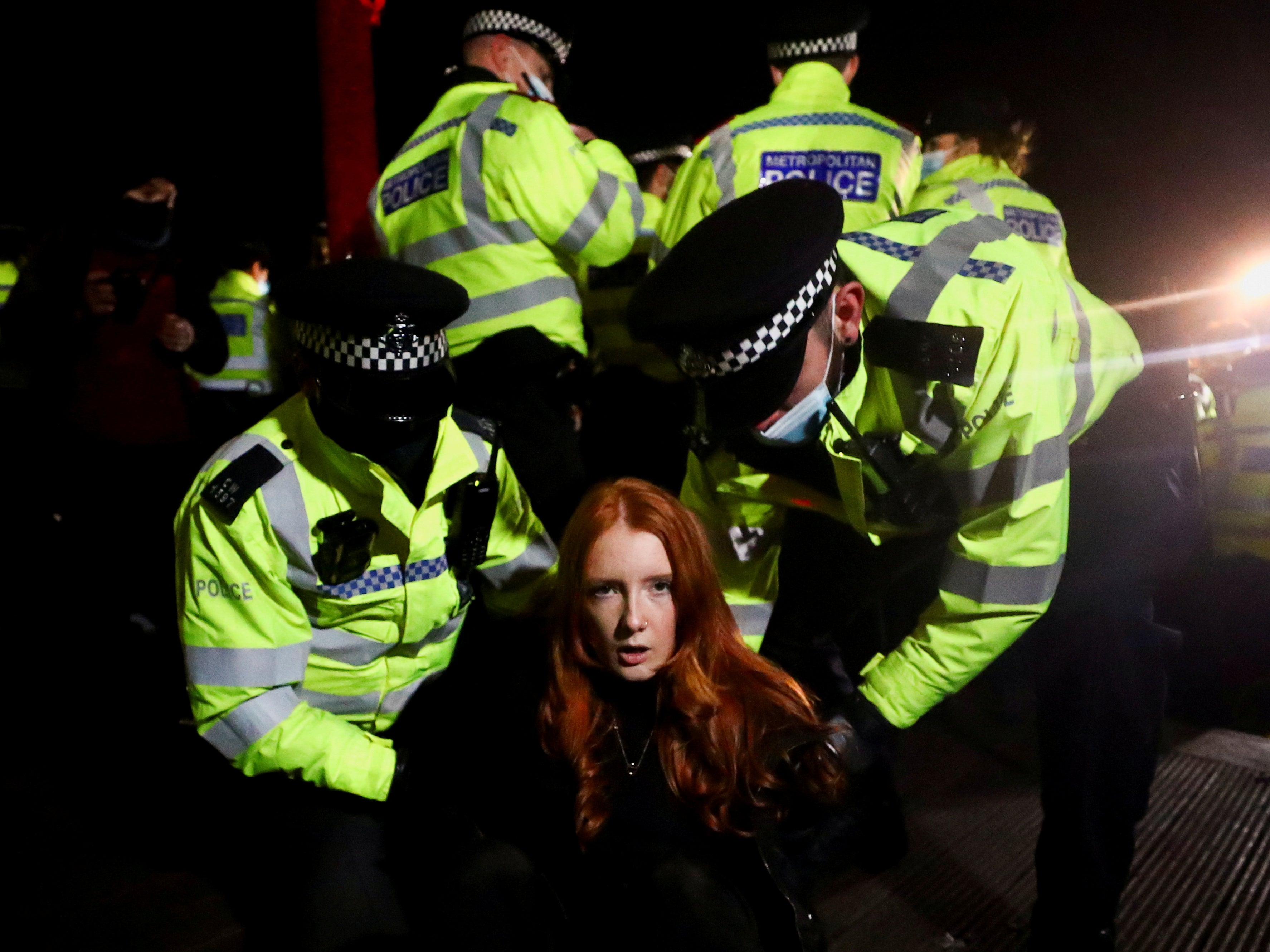 Police detain Patsy Stevenson at a memorial site in Clapham Common