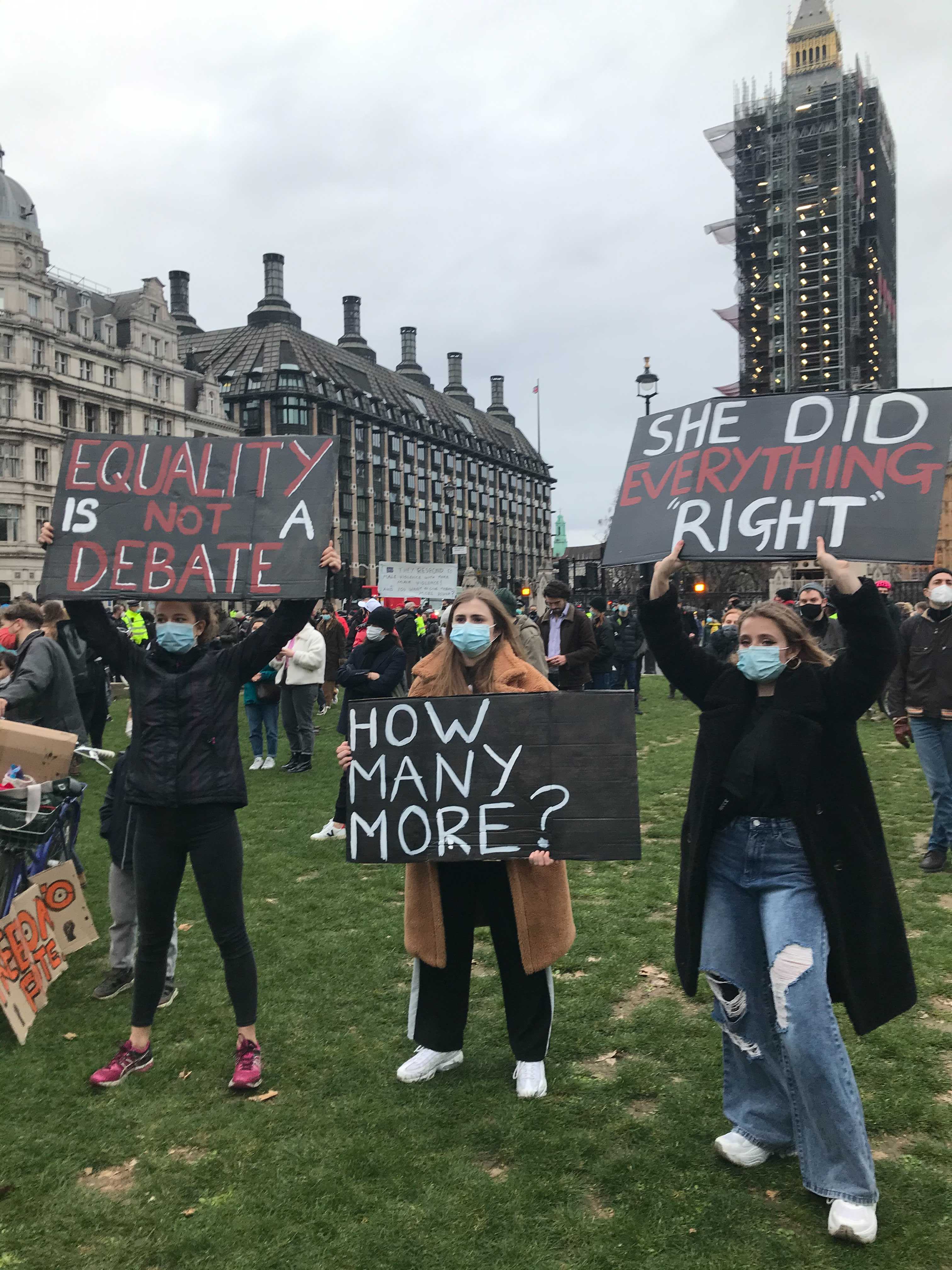 Protesters hold placards at Parliament Square