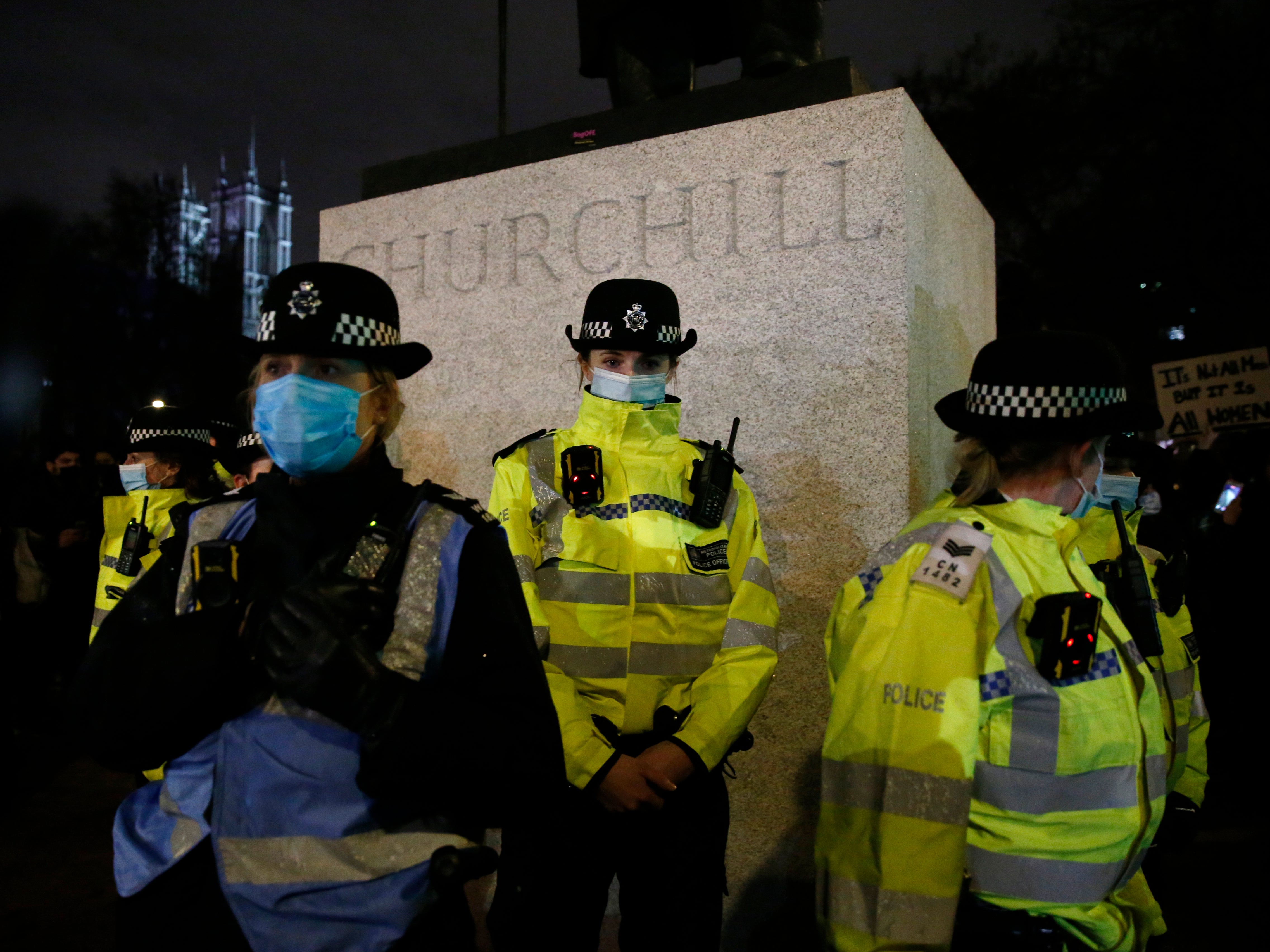 Female police officers surround the statue of Winston Churchill on Parliament Square Gardens