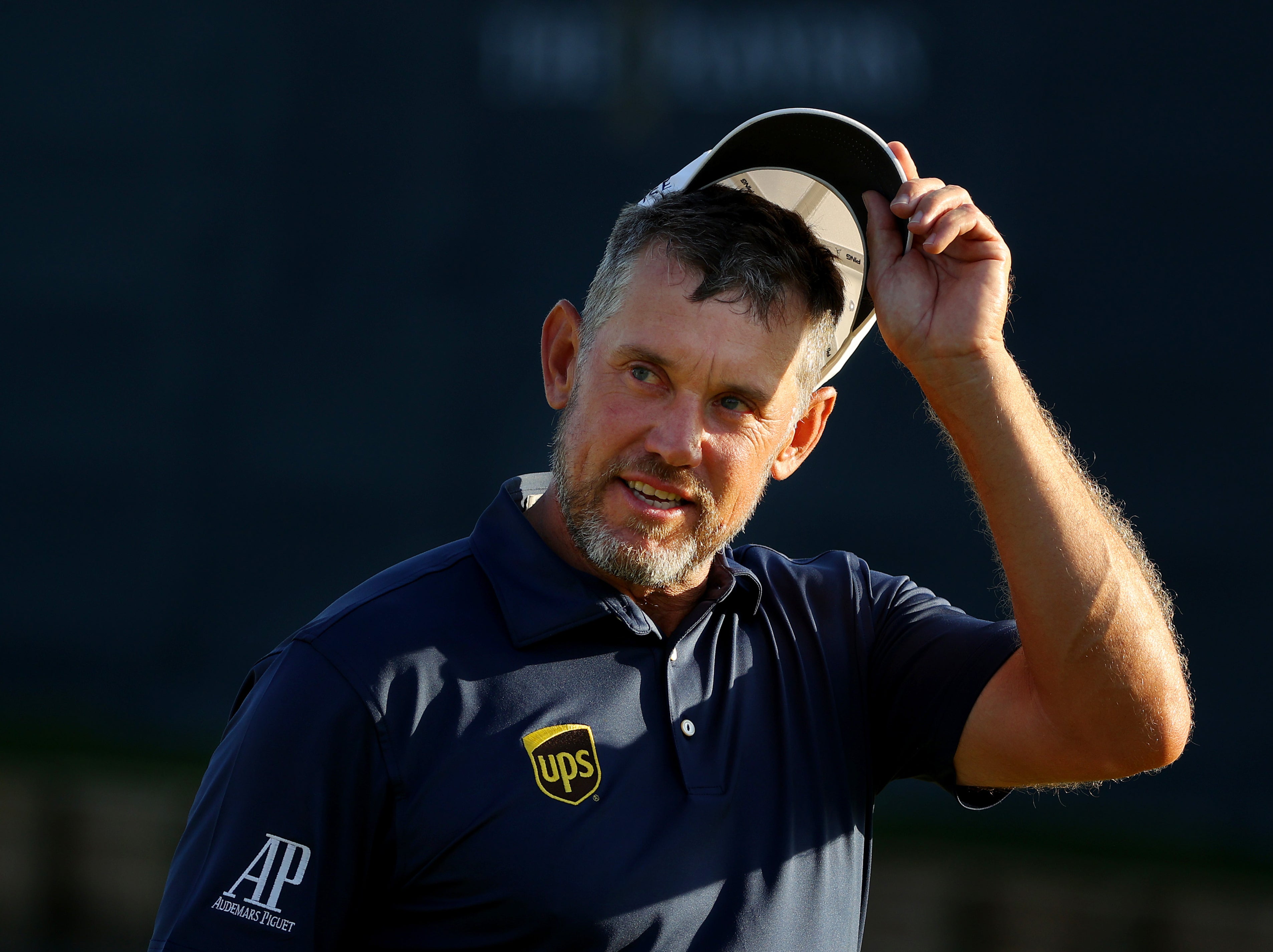 Lee Westwood tips his at on the 18th green at TPC Sawgrass