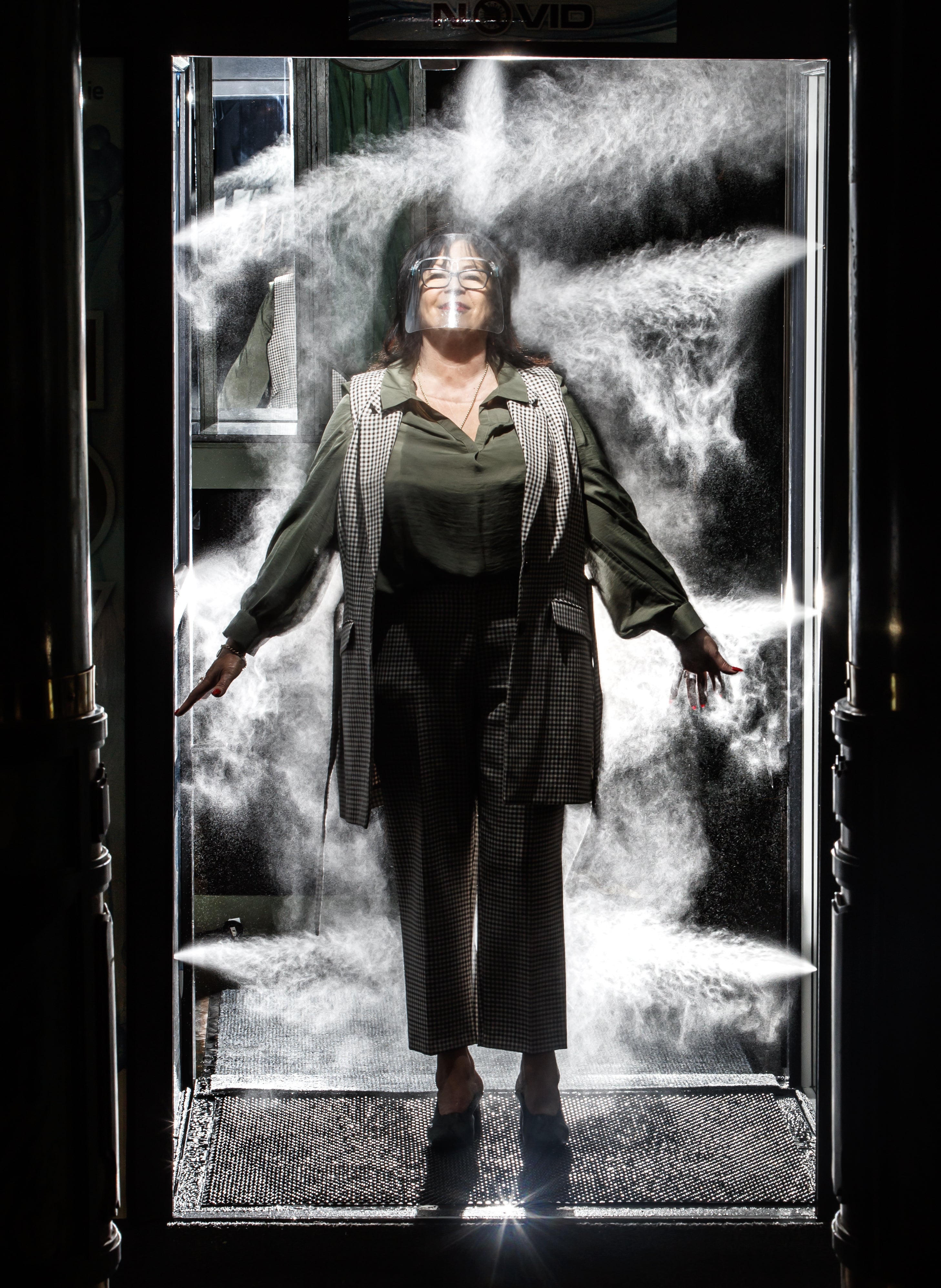 Maureen Bramwell, the owner of the Grand Central venue in Liverpool, stands in a NOVID sanitisation booth during a demonstration in the city centre on 2 October 2020.