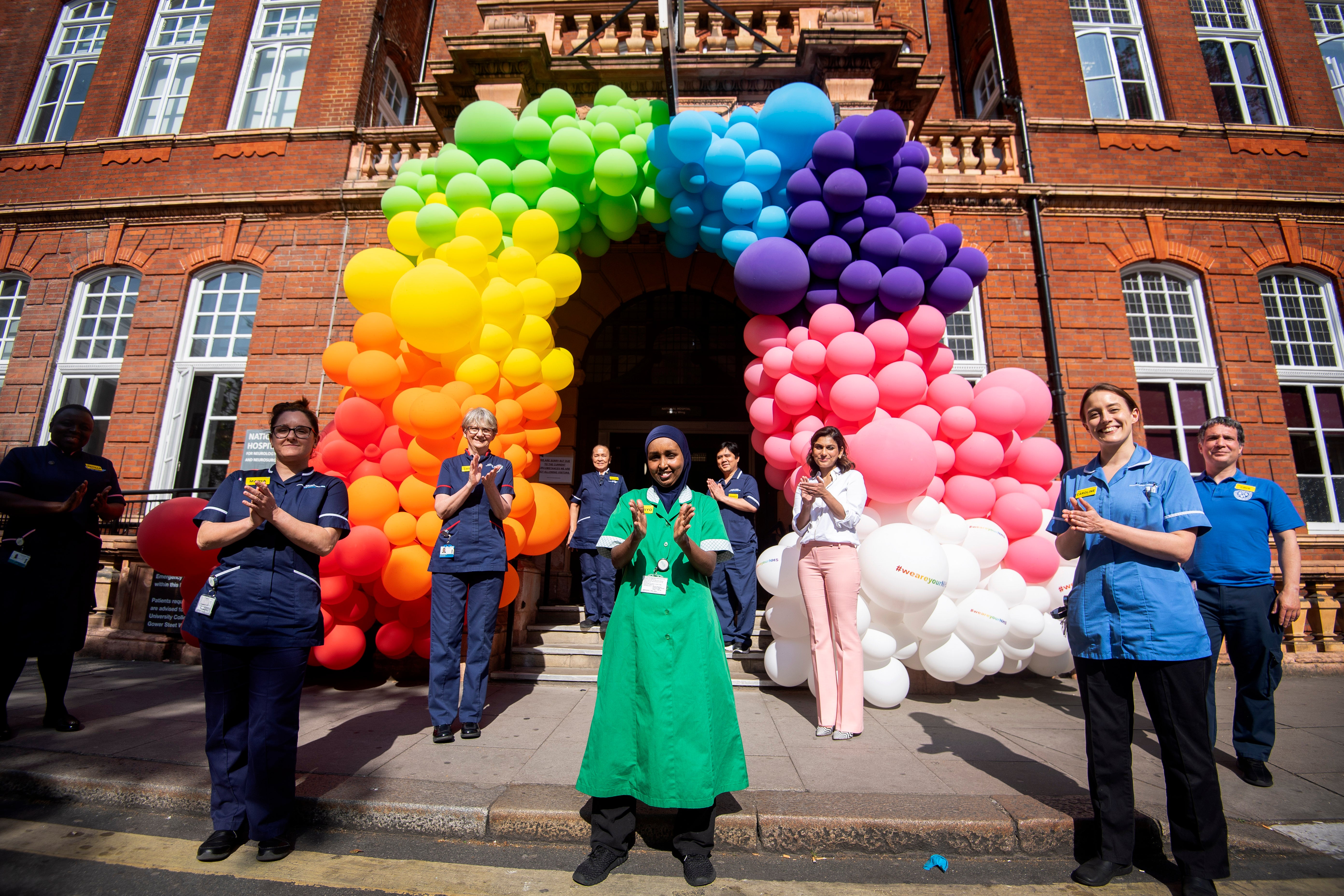 NHS nurses, surgeons, doctors and support staff help to unveil a rainbow balloon display outside the National Hospital for Neurology and Neurosurgery in Holborn, London to thank the public for their support during the ongoing Coronavirus pandemic