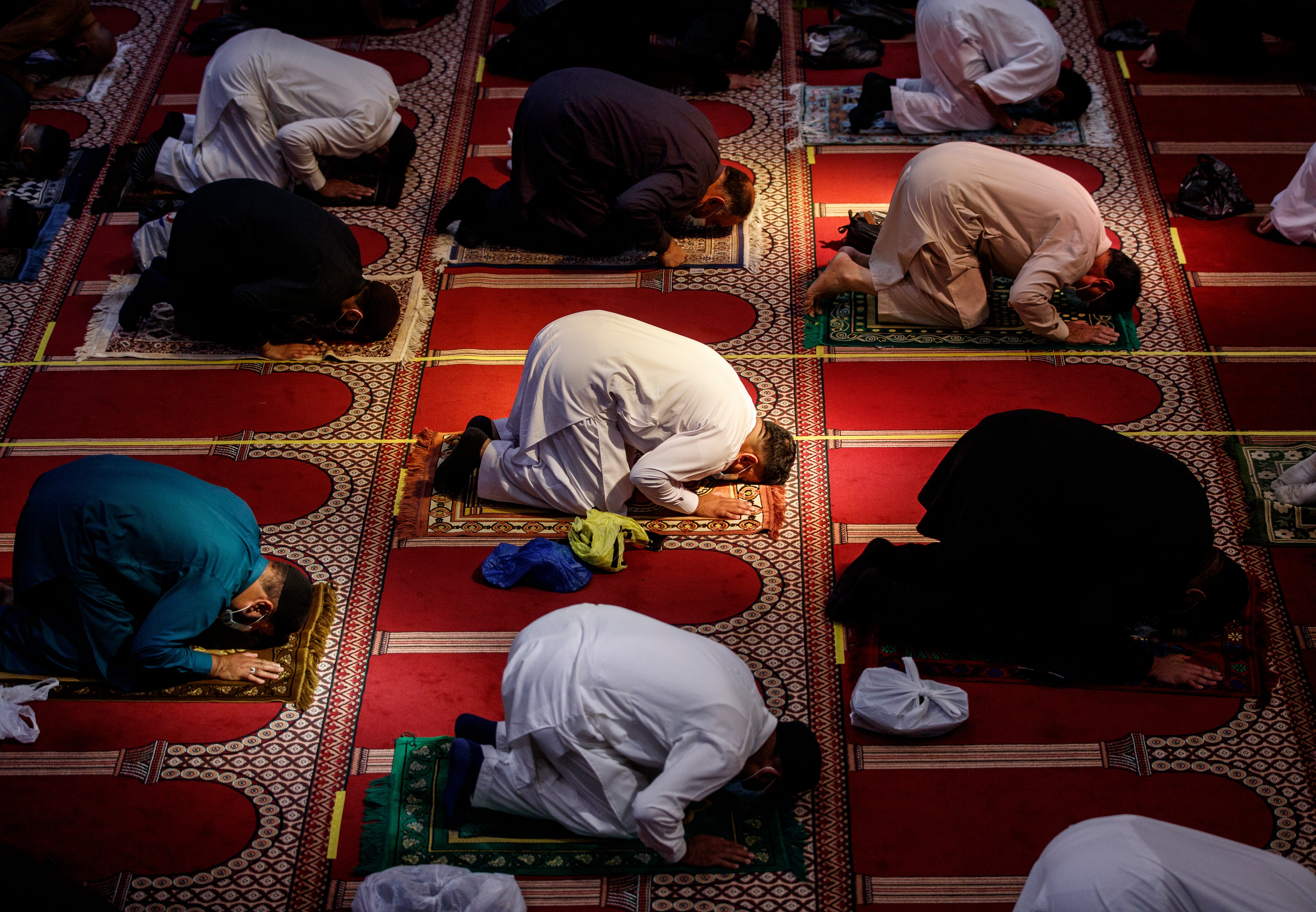 Worshippers observe social distancing at the Bradford Central Mosque on the first day of Eid, in Bradford, West Yorkshire. The Area was one of several in the north of the country where measures were suddenly introduced just a day ahead of the religious festival.