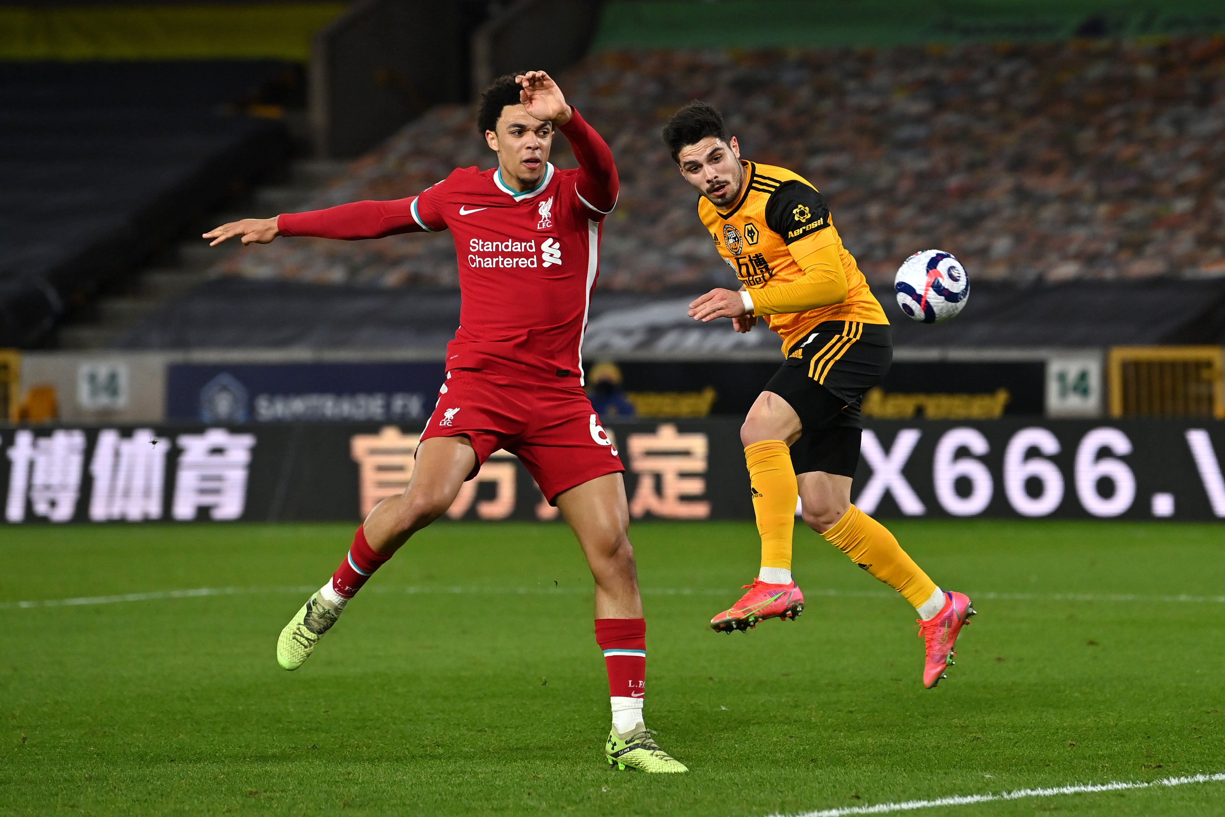 Pedro Neto misses a header under pressure from Trent Alexander-Arnold