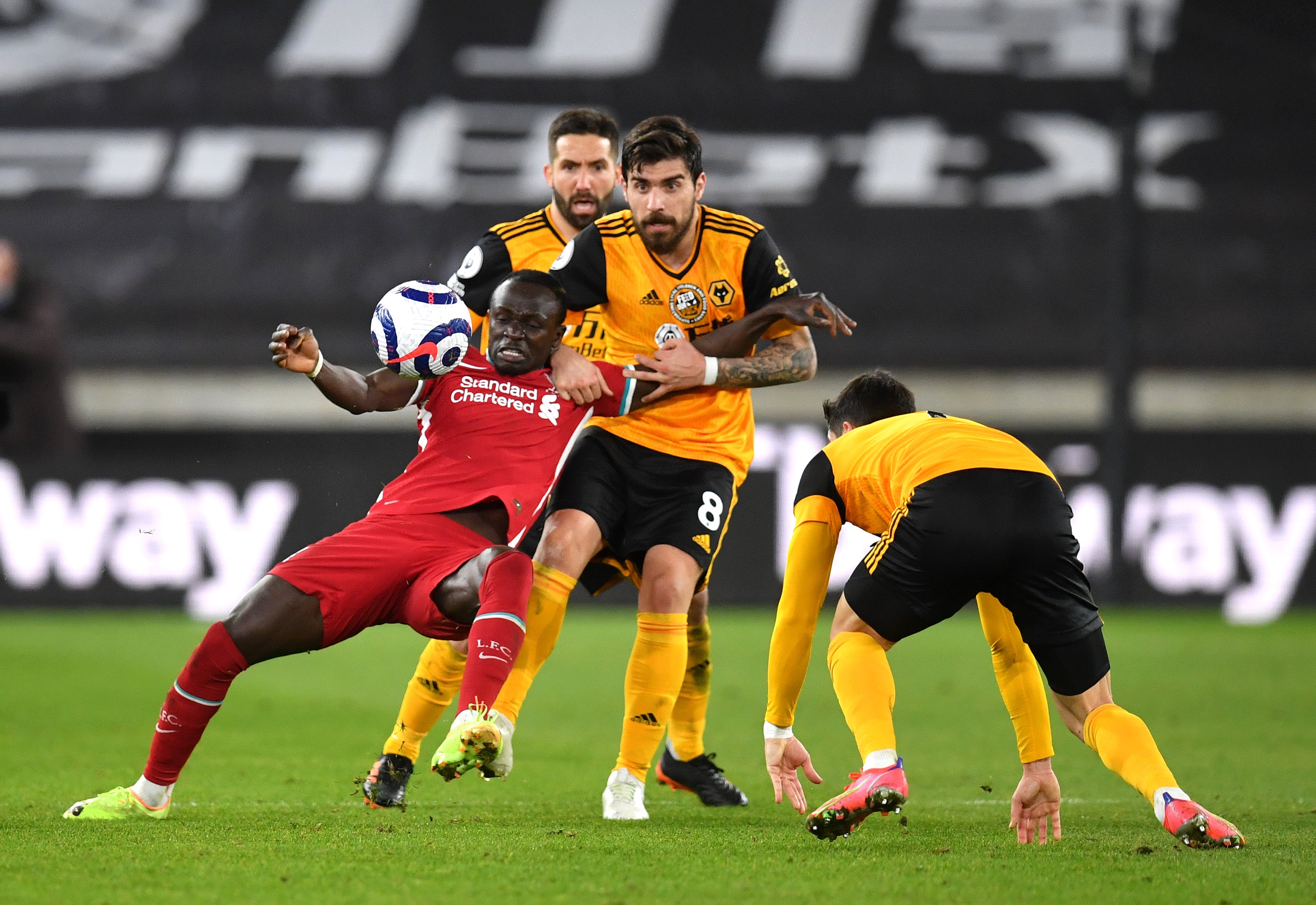 Sadio Mane is challenged by Ruben Neves