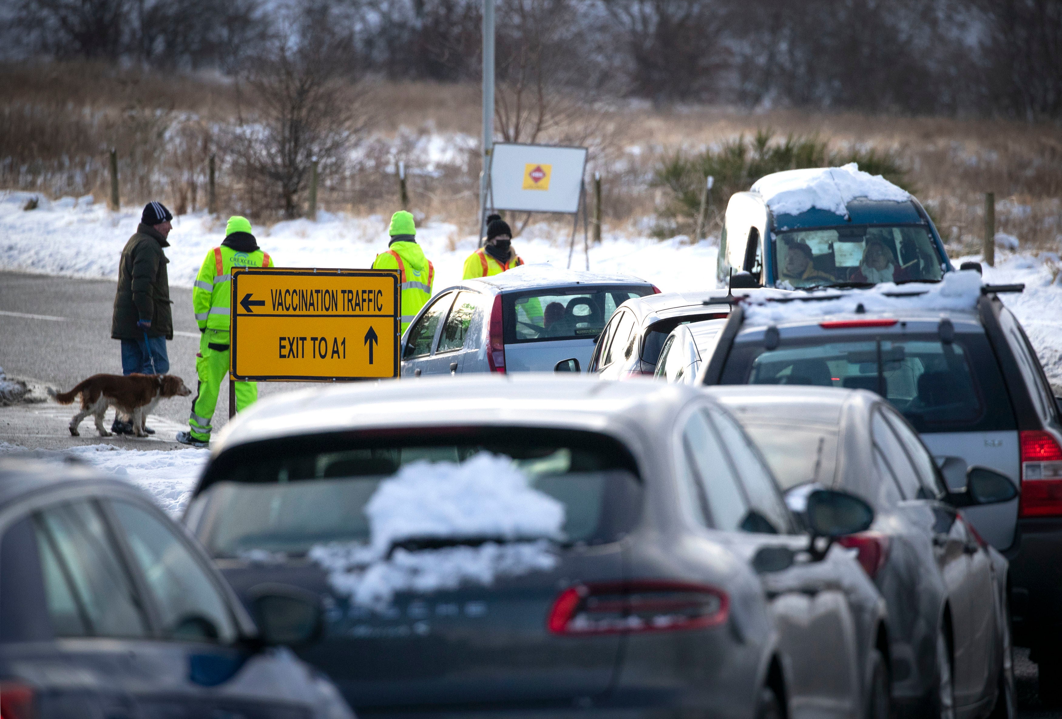 People queue at the drive-through Covid-19 vaccination centre in the Queen Margaret University Campus, Musselburgh, Scotland