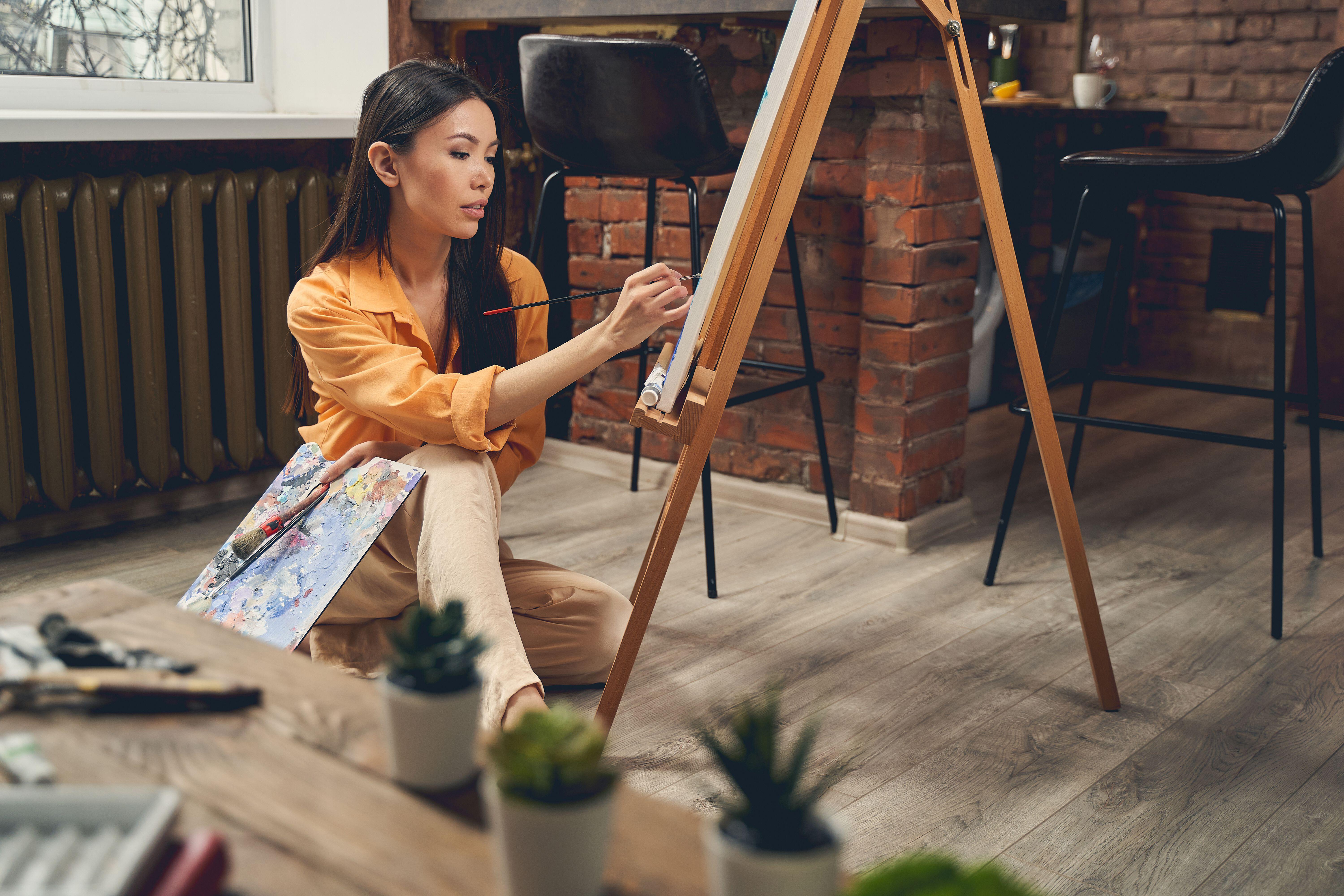 A woman painting at home