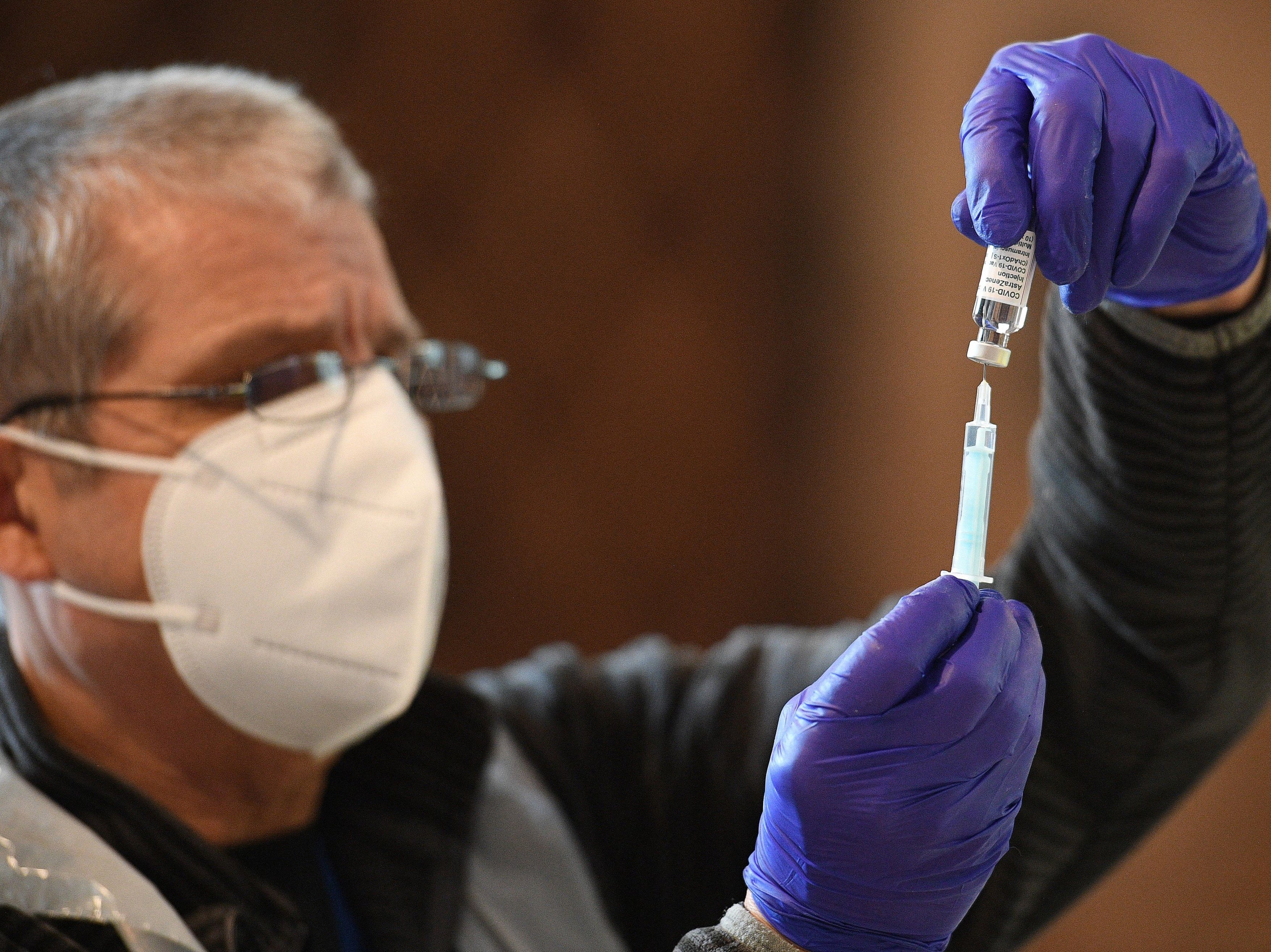 Dr Andy Wakeman prepares a dose of the Oxford/AstraZeneca Covid-19 vaccine at Lichfield cathedral