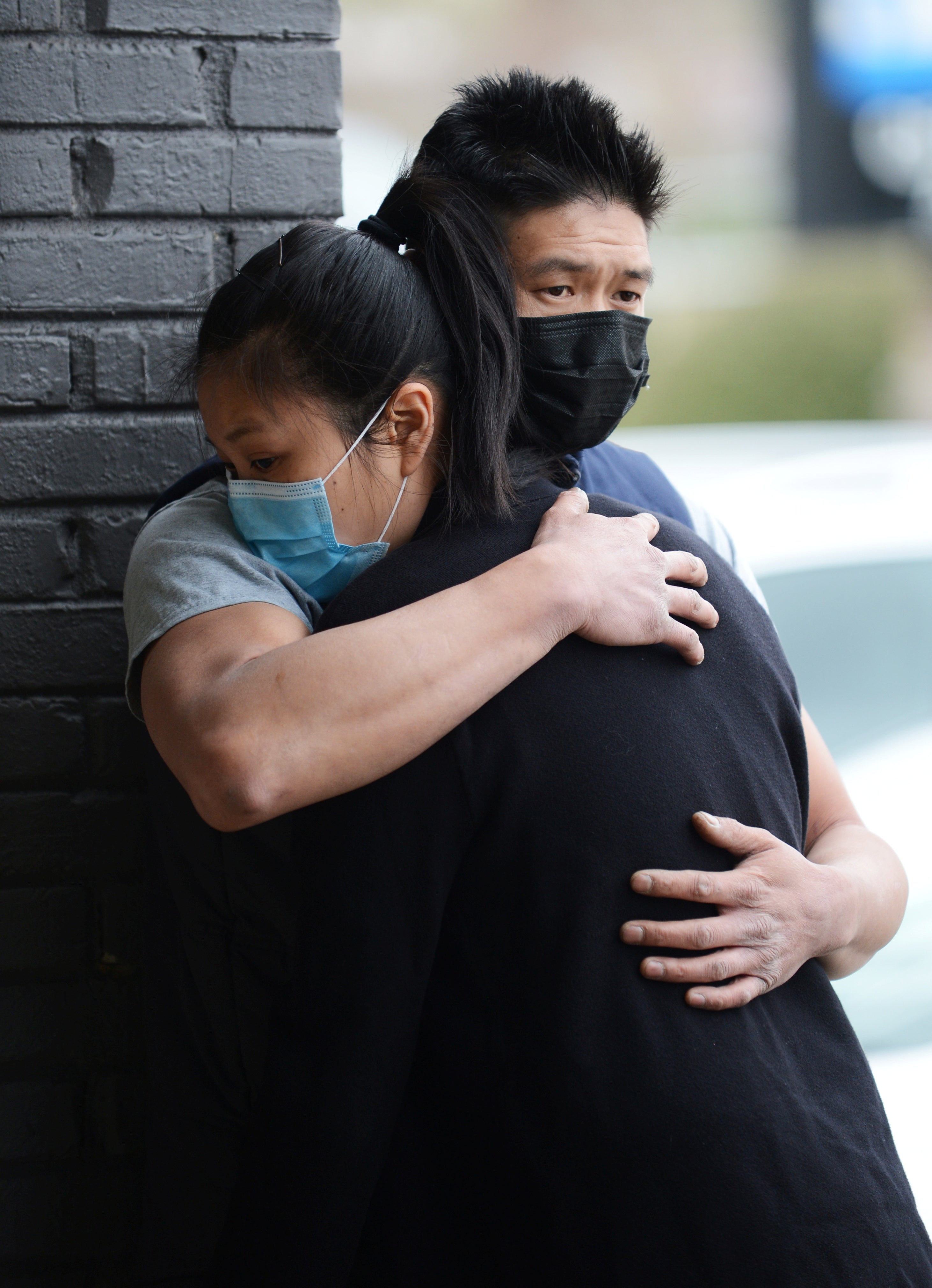 Kevin Chen consoles his fiancee Jami Webb outside Young's Asian Massage following the deadly shootings in Acworth, Georgia, U.S. March 19, 2021. Webb is the daughter of Xiaojie Tan, the owner of the spa who was killed in the shootings.