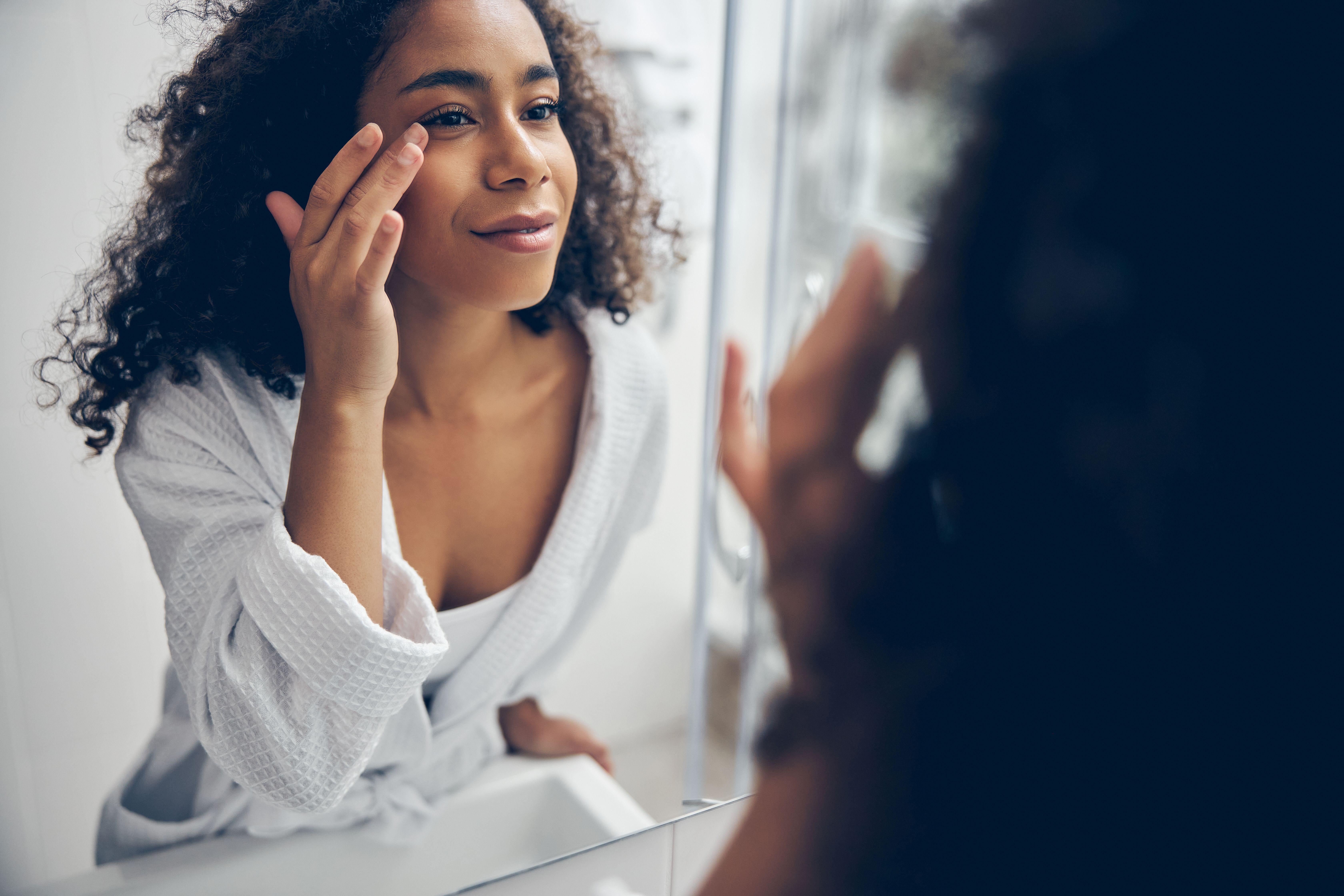 woman looking in mirror