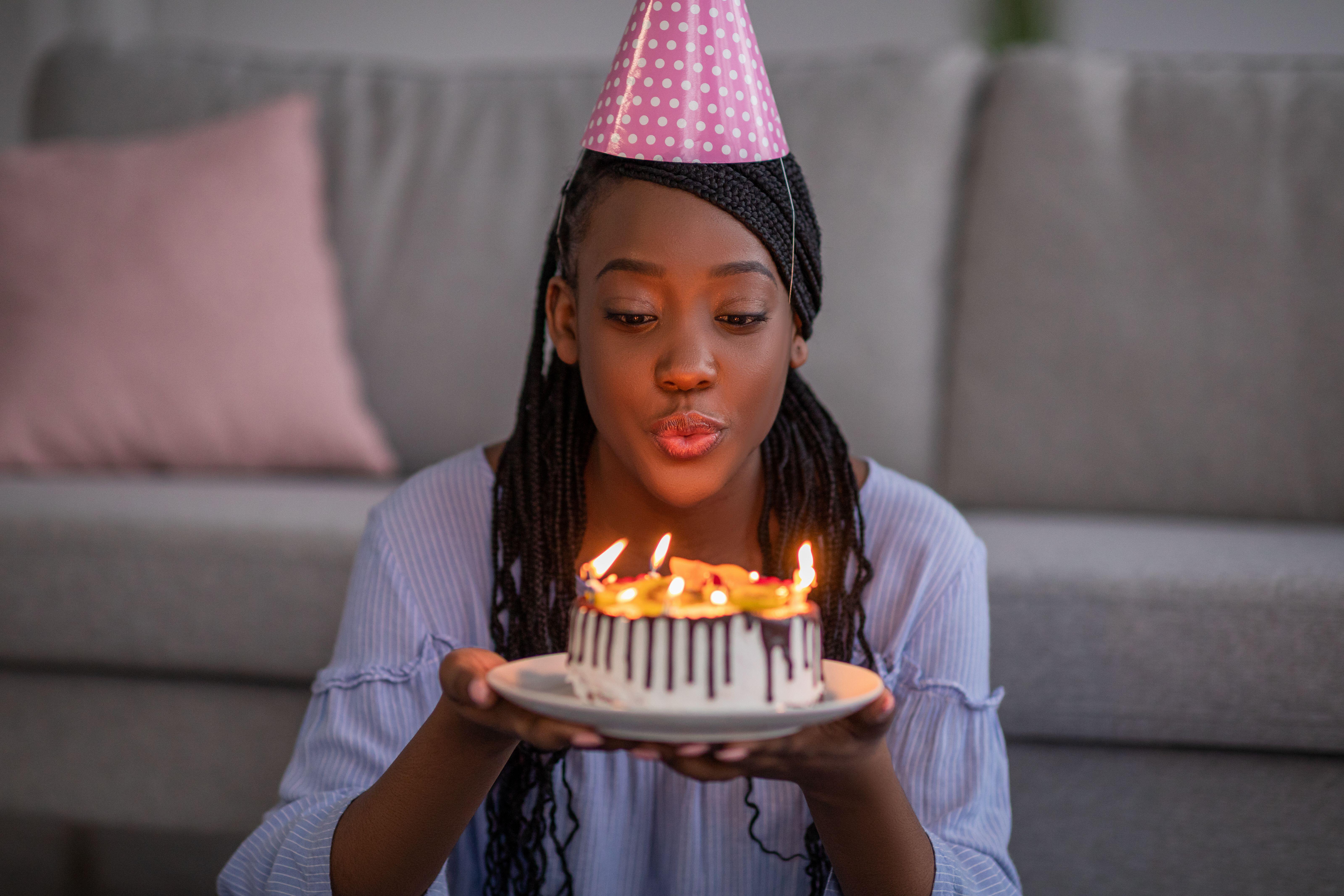 blowing candles out on cake