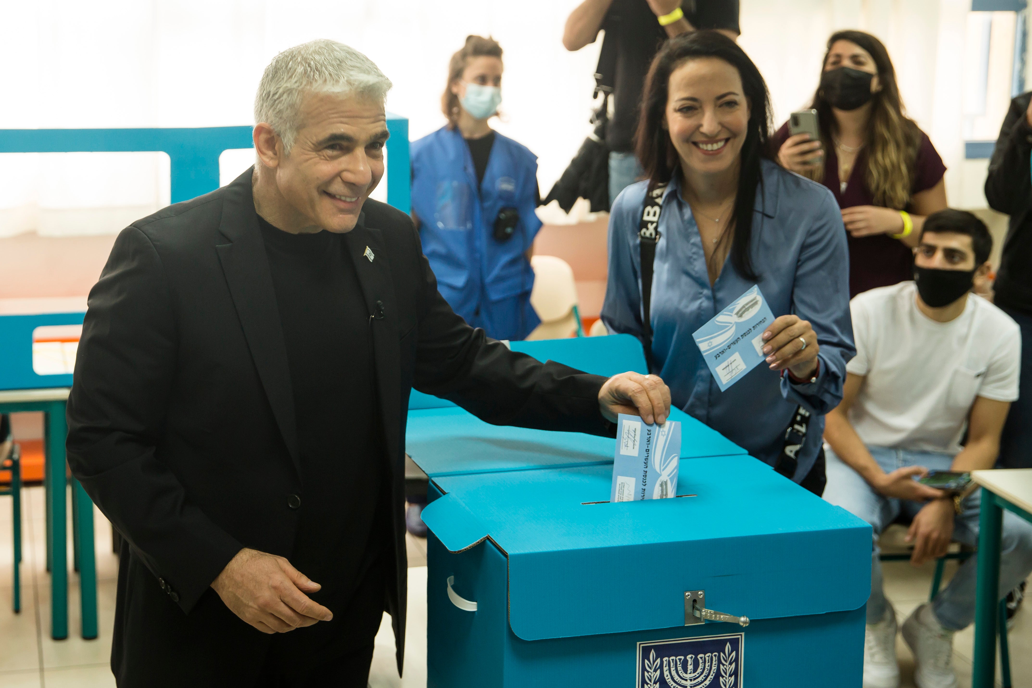 Yair Lapid, the leader of Yesh Atid, and his wife Lihi cast their votes in Tel Aviv.