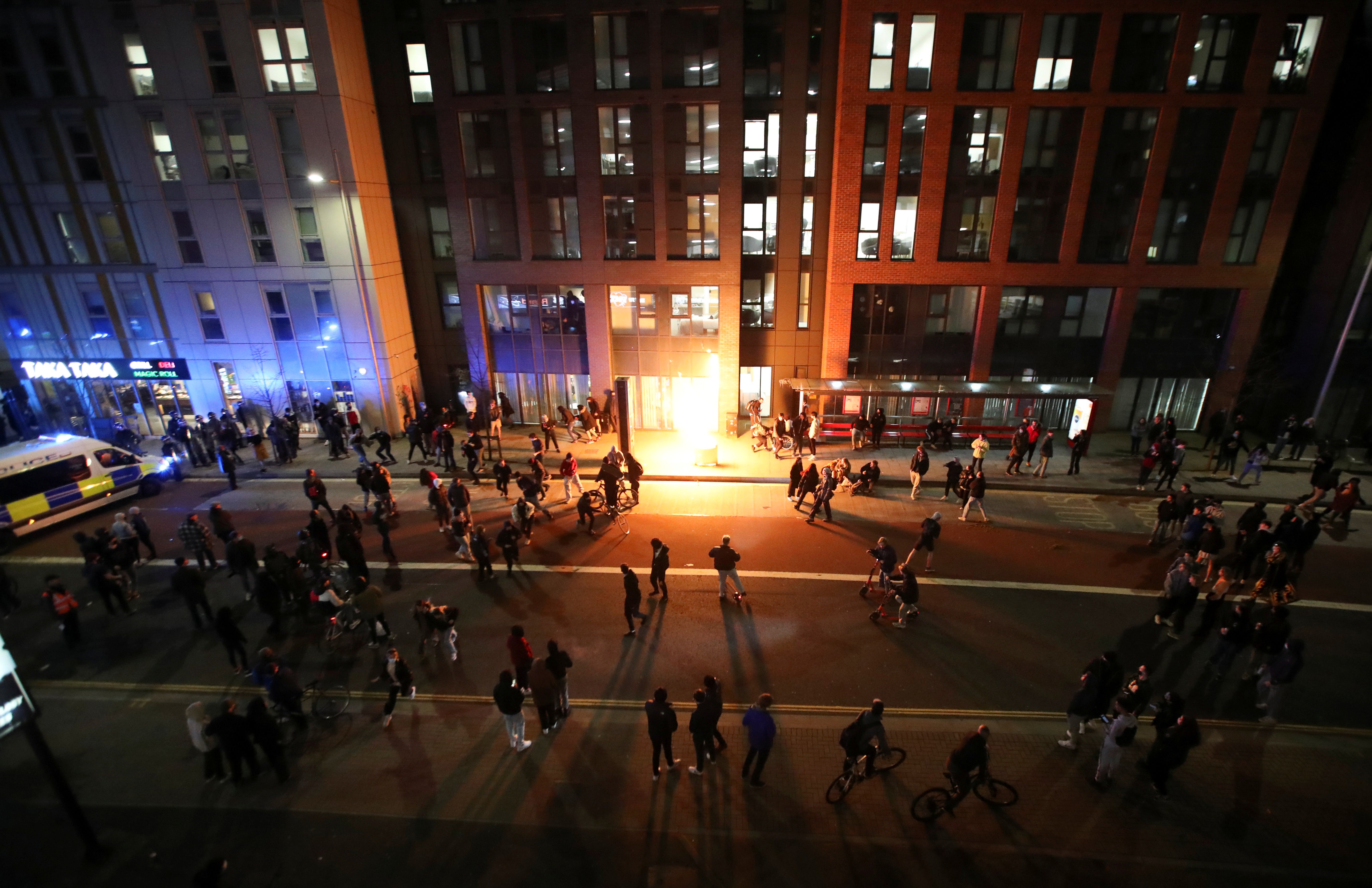 A bin is set on fire and explodes during riots in Bristol on Sunday