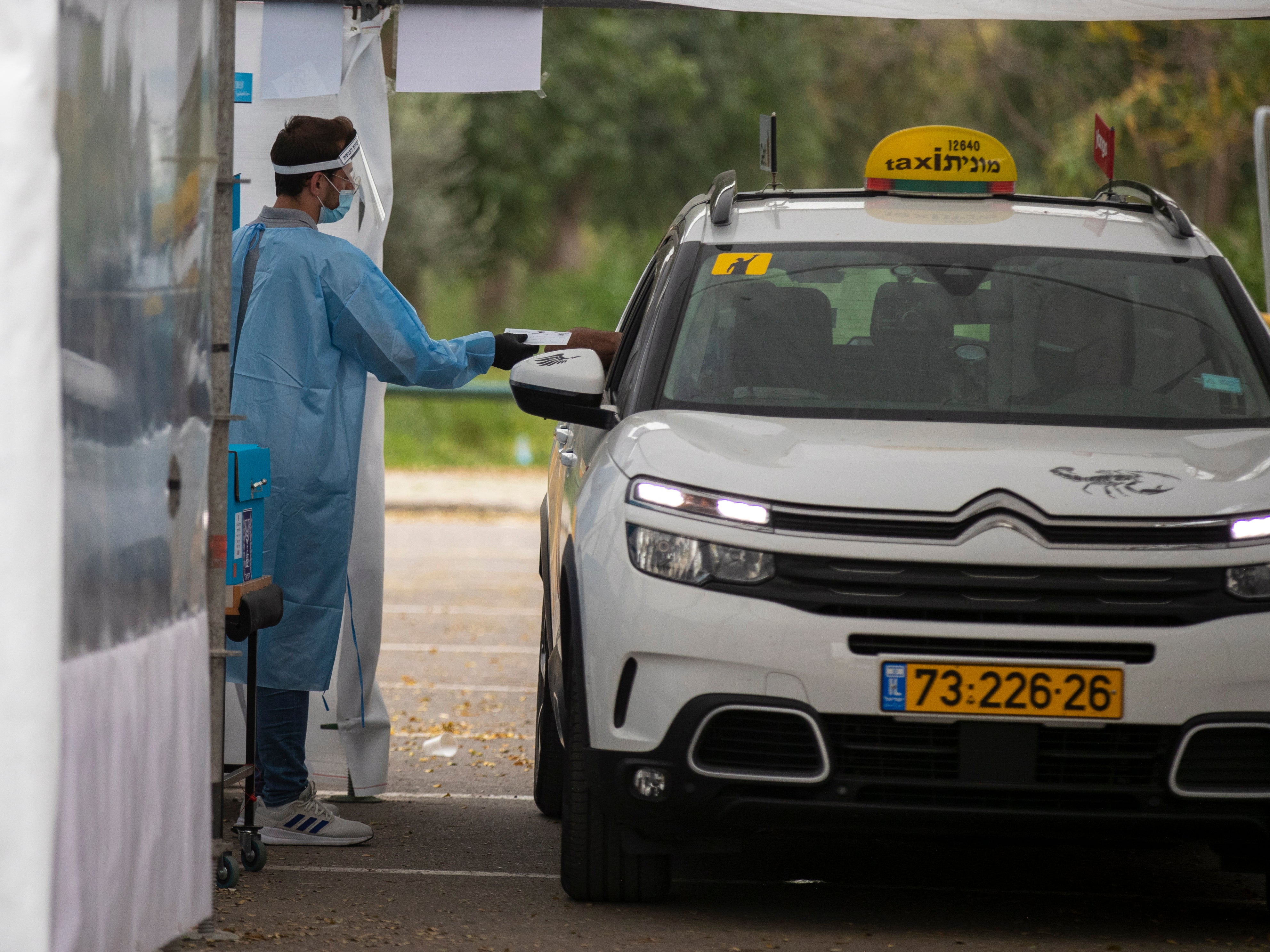 An Israeli man in quarantine casts his ballot at a special polling stations in Tel Aviv