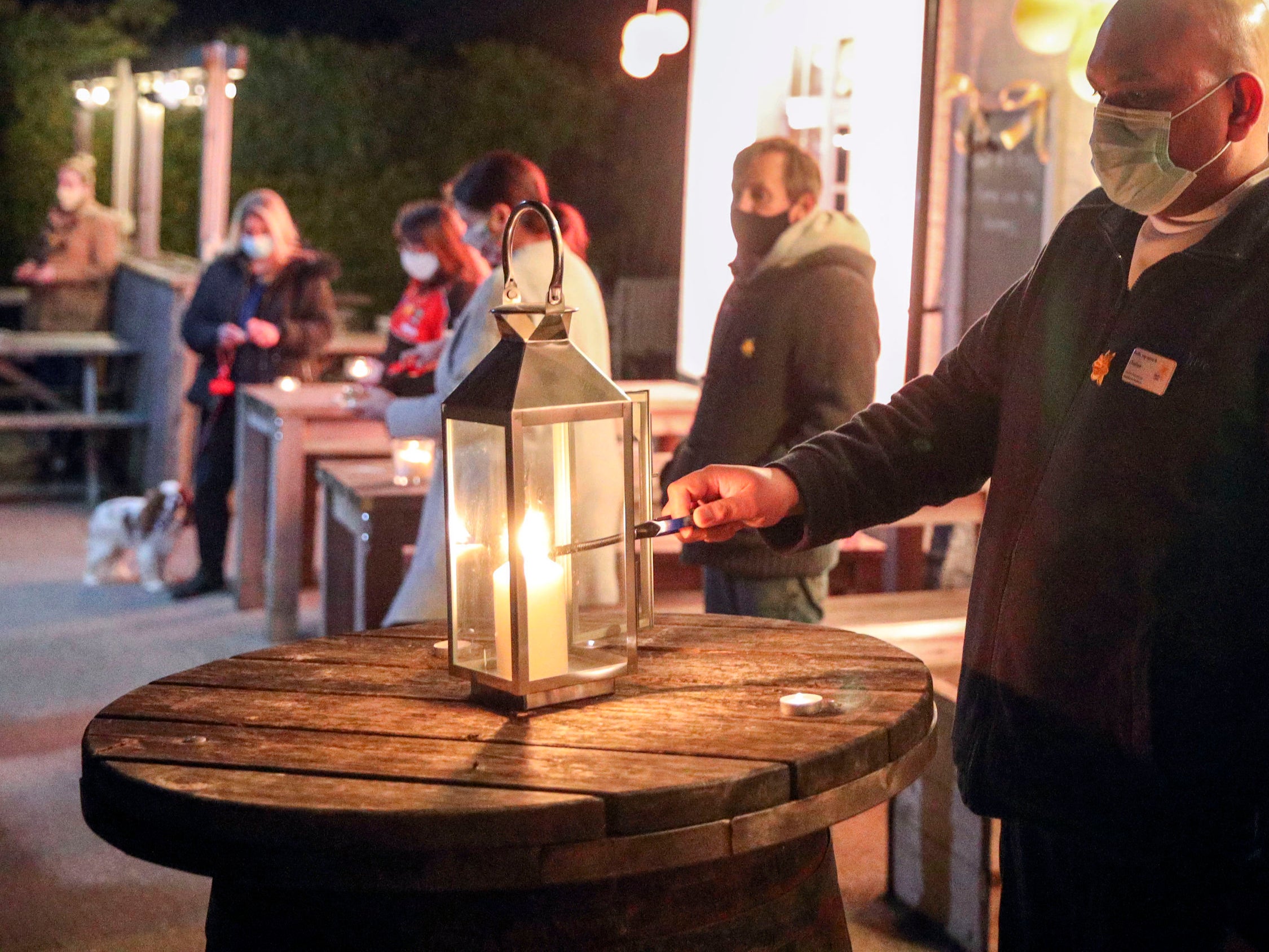 Candles lit outside the Old House at Home pub in Surrey as Britain marks the anniversary of the first Covid lockdown