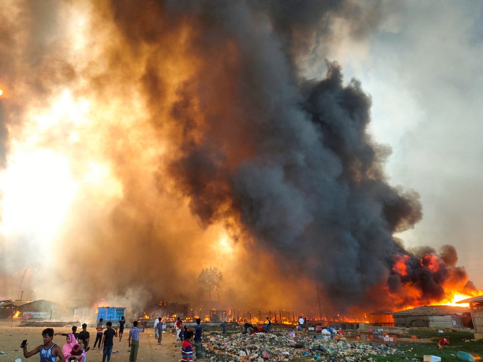 Smoke rises high above the camp as the blaze takes hold