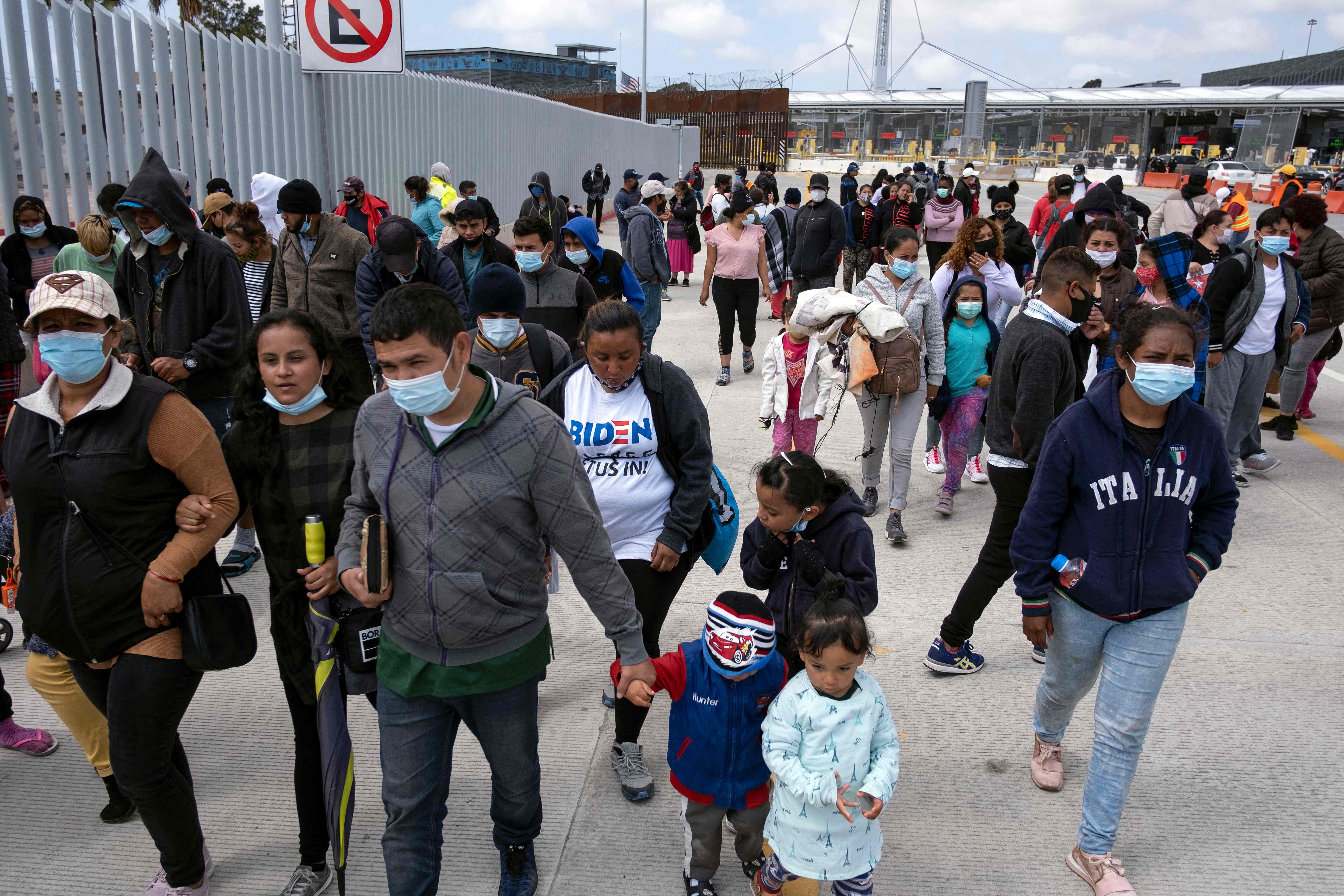 Migrants and asylum seekers awl after a demonstration at the San Ysidro crossing port asking US authorities to allow them to start their migration process in Tijuana, Baja California state, Mexico on 23 March 2021.