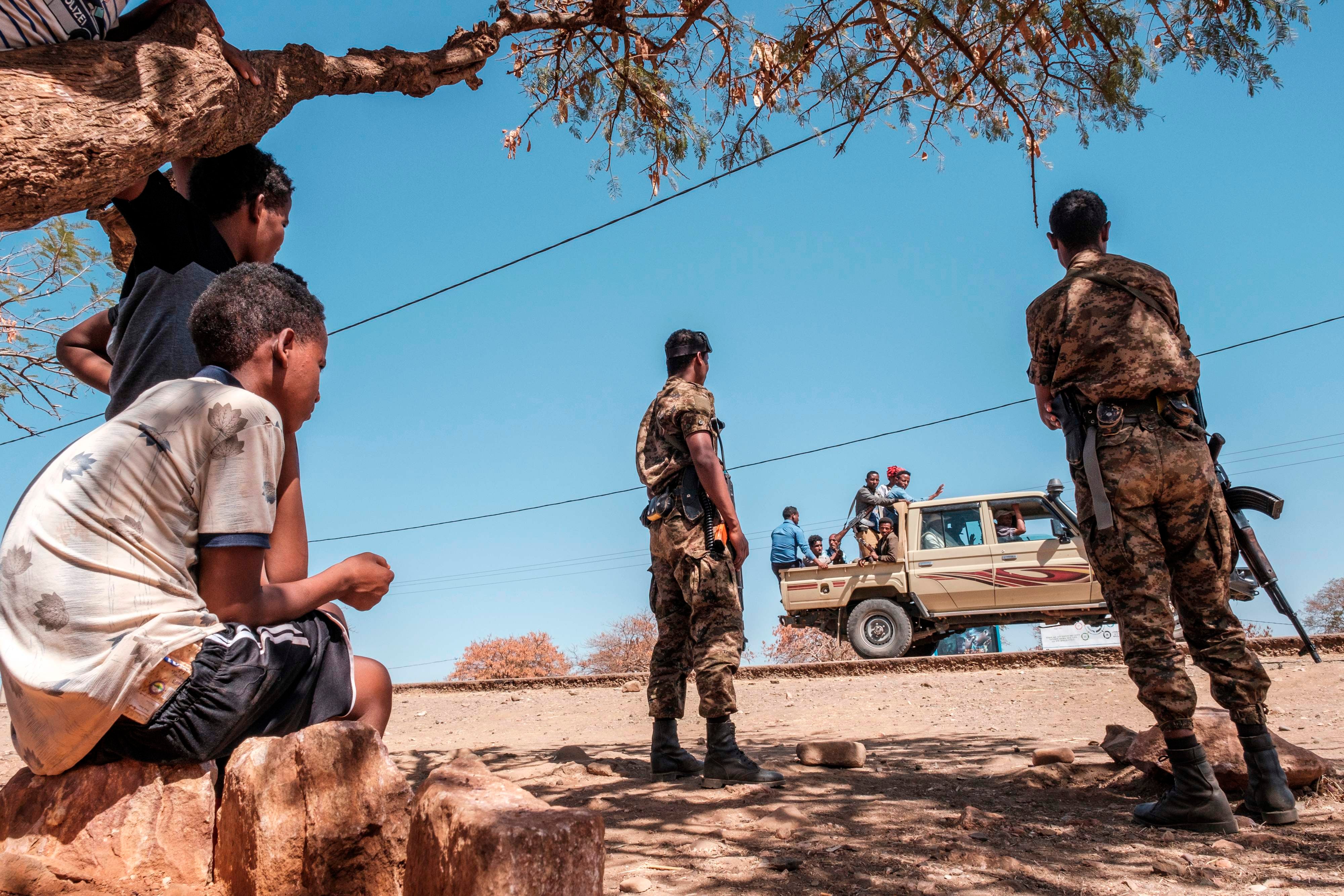 Ethiopian army soldiers watch a truck full of militia men at Mai Aini Refugee camp, housing Eritrean refugees in Ethiopia