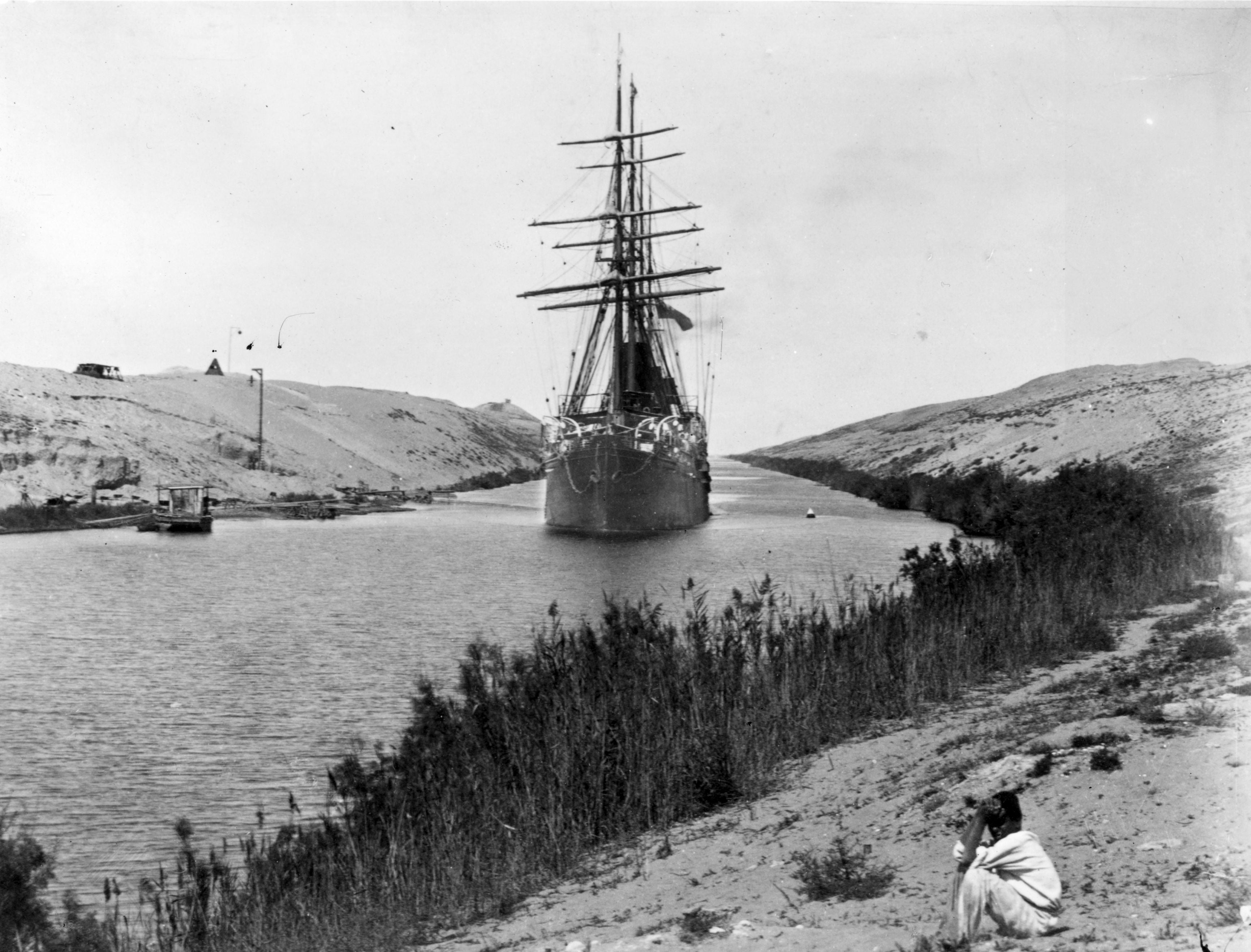 A French frigate passes through the Channel of the Suez Canal, opened in 1869.