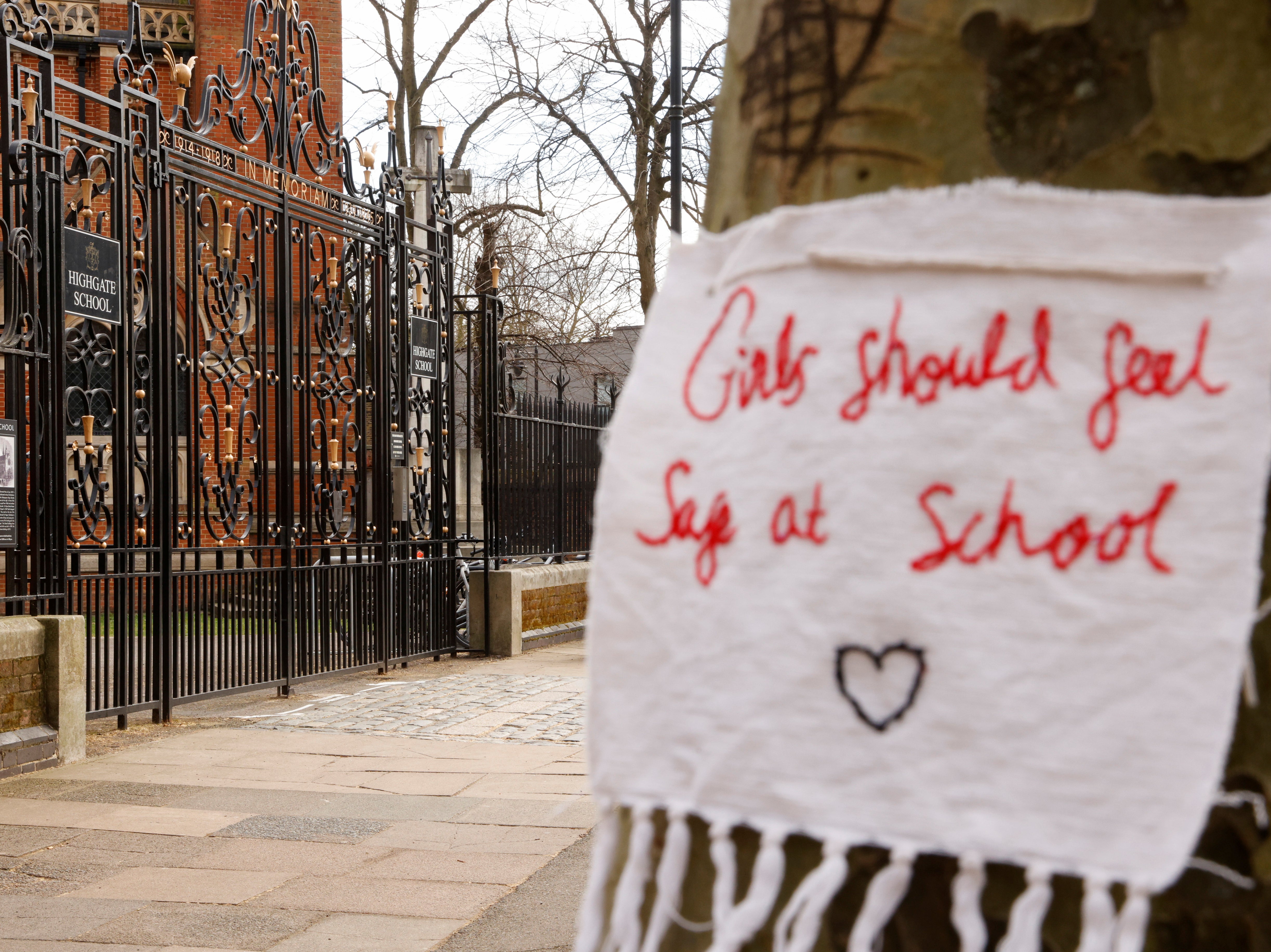 A sign saying ‘girls should feel safe at school’ hangs outside Highgate School, where pupils have also faced allegations