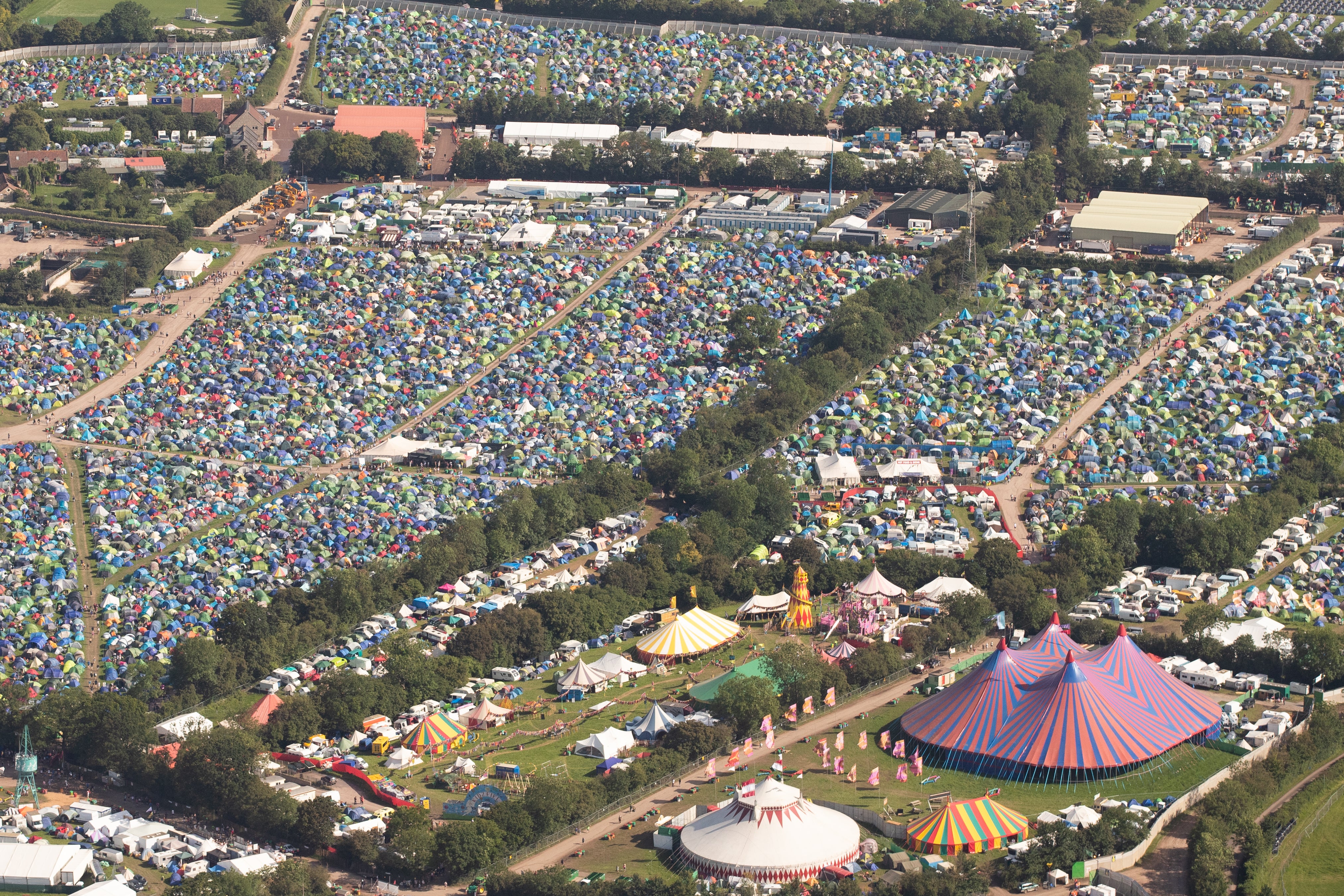 Festival goers cover fields with tents each year