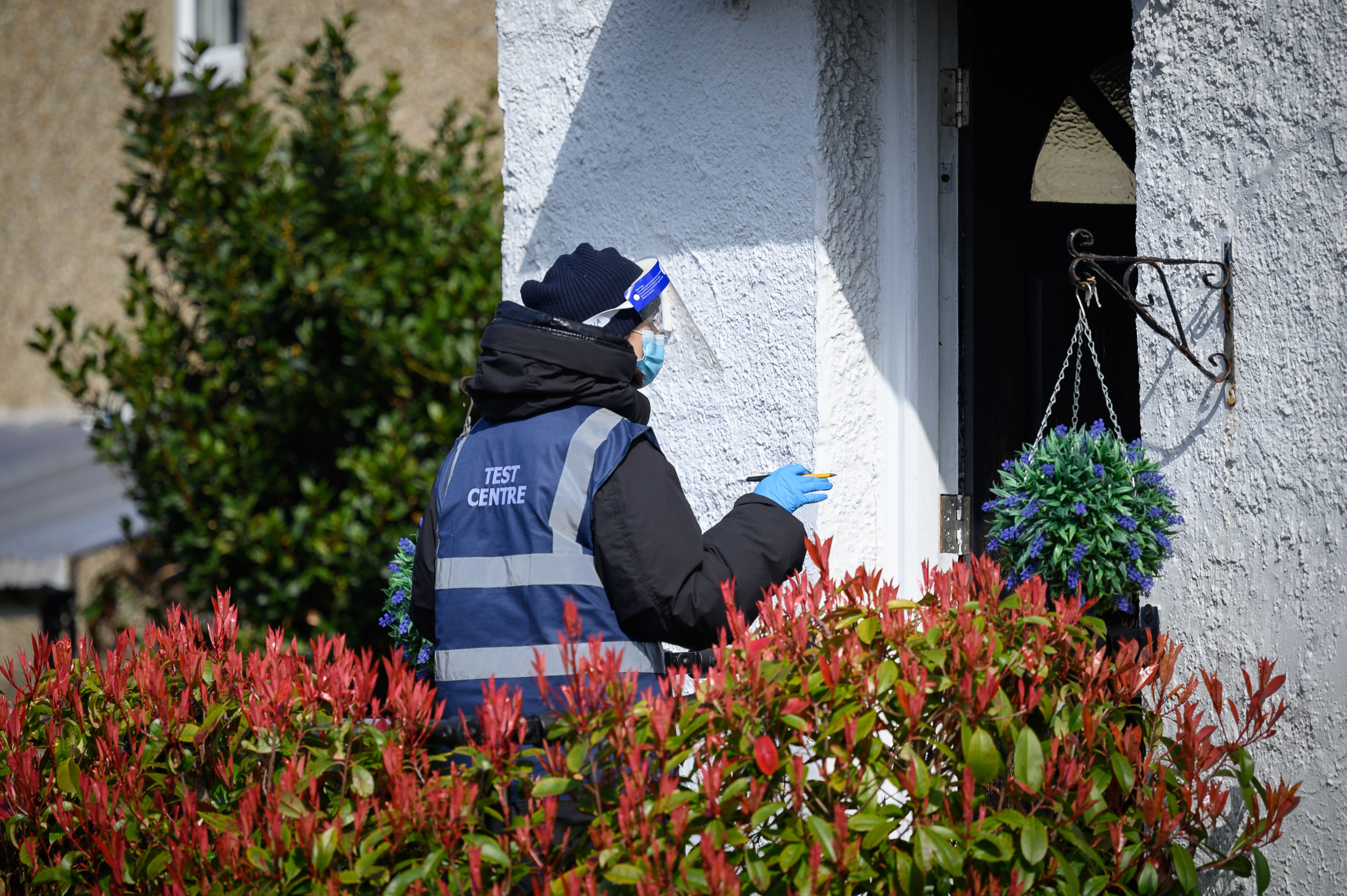 Volunteers deliver Covid-19 test kits to the doors of residents in a specific postcode near Muswell Hill, London on 22 March