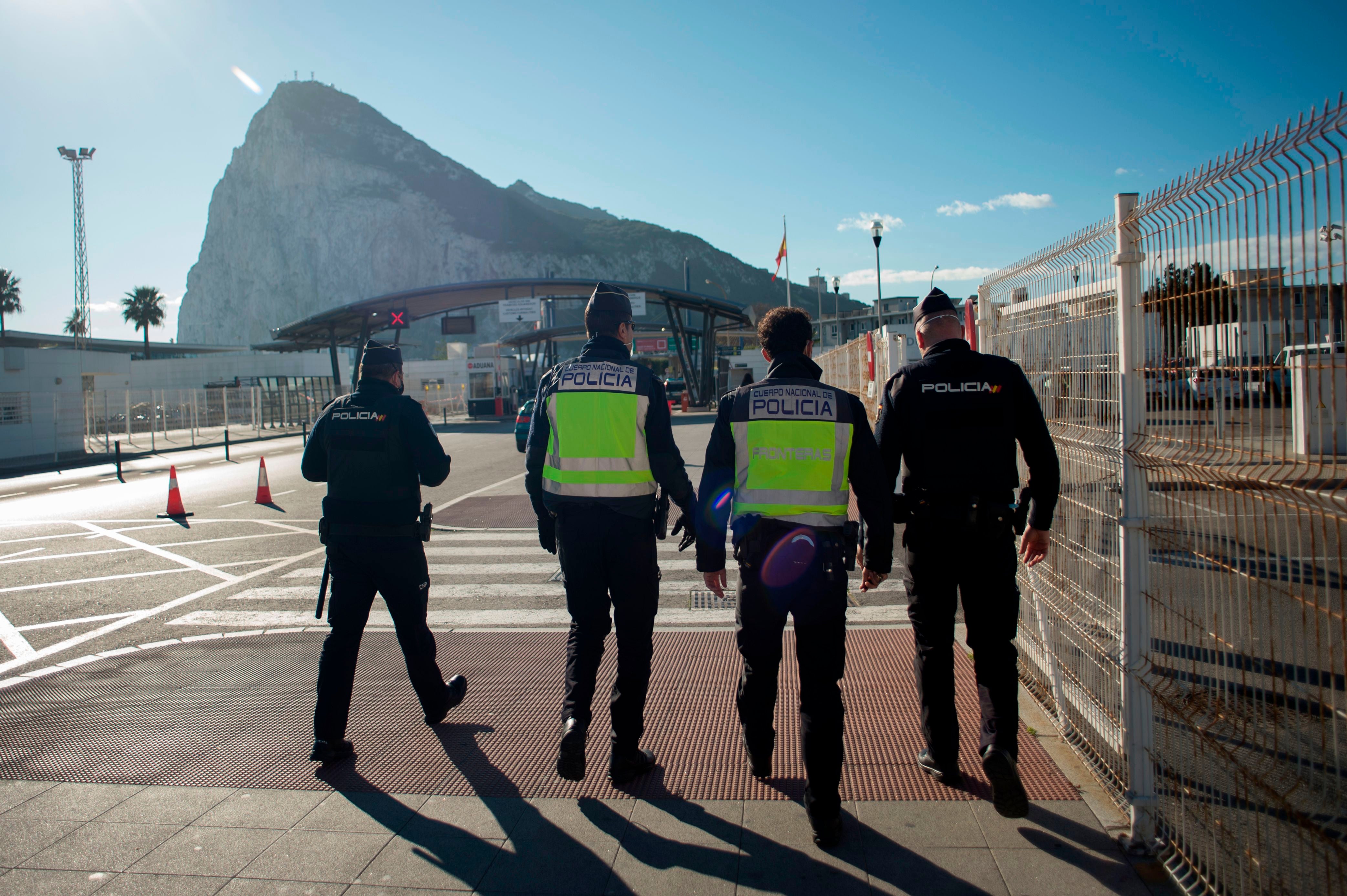 Police officers patrol the border between Spain and Gibraltar