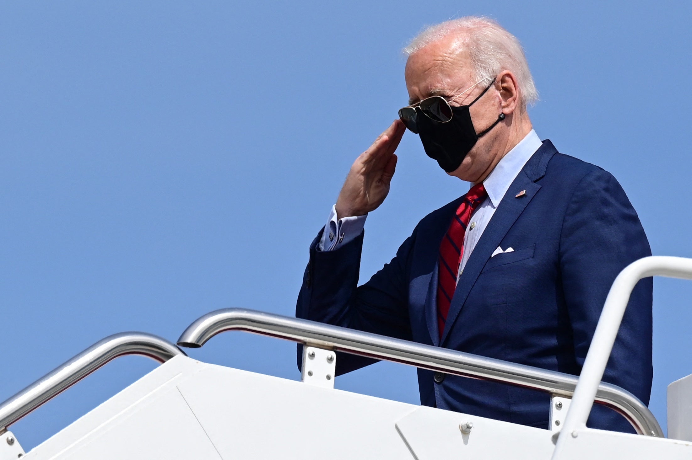 President Joe Biden salutes as he boards Air Force One. The sooner Americans and Britons can take to the air again, the better