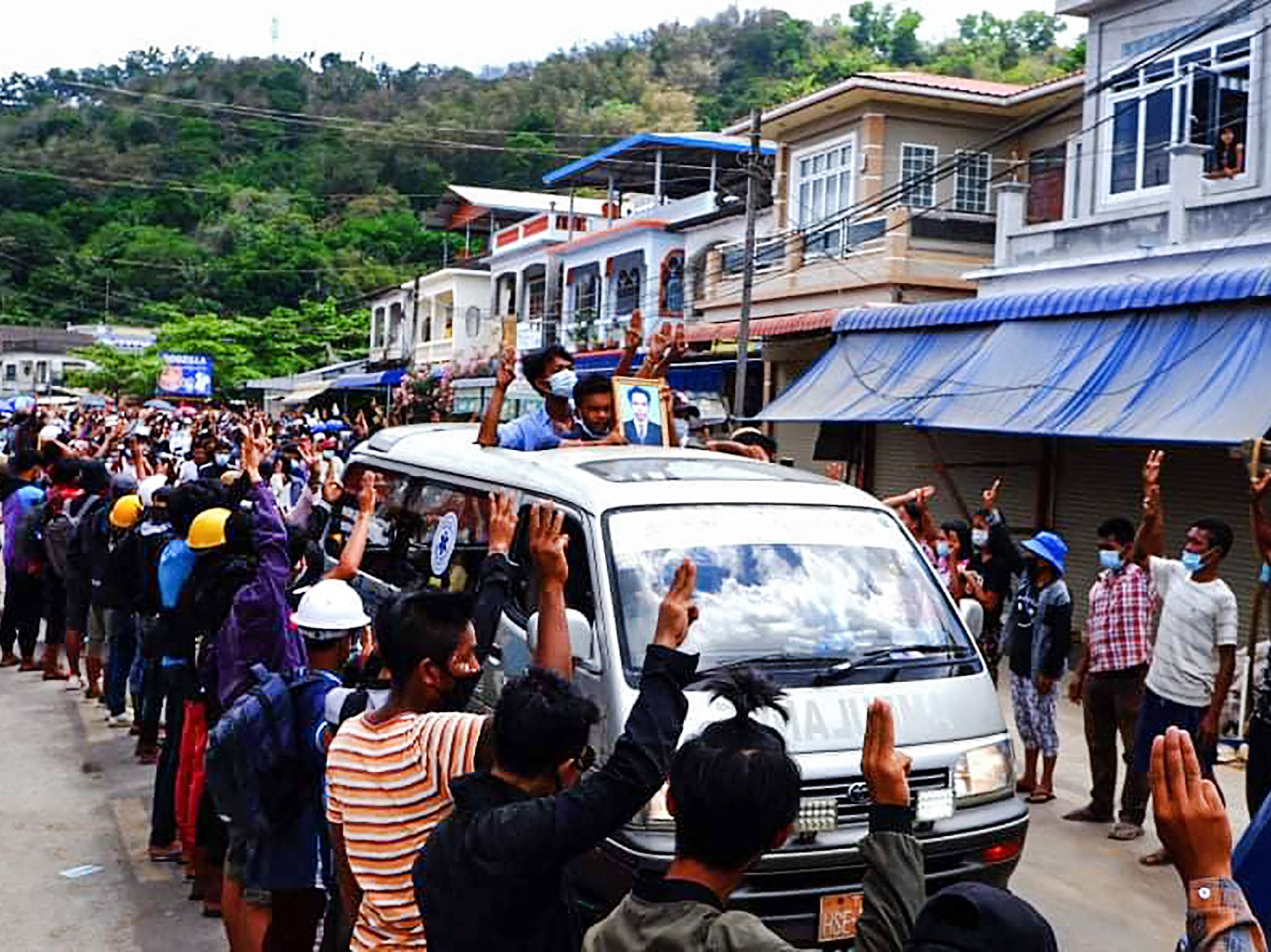 Mourners make the three-finger protest salute during a funeral procession for a demonstrator who was shot dead in Kawthaung in southern Myanmar