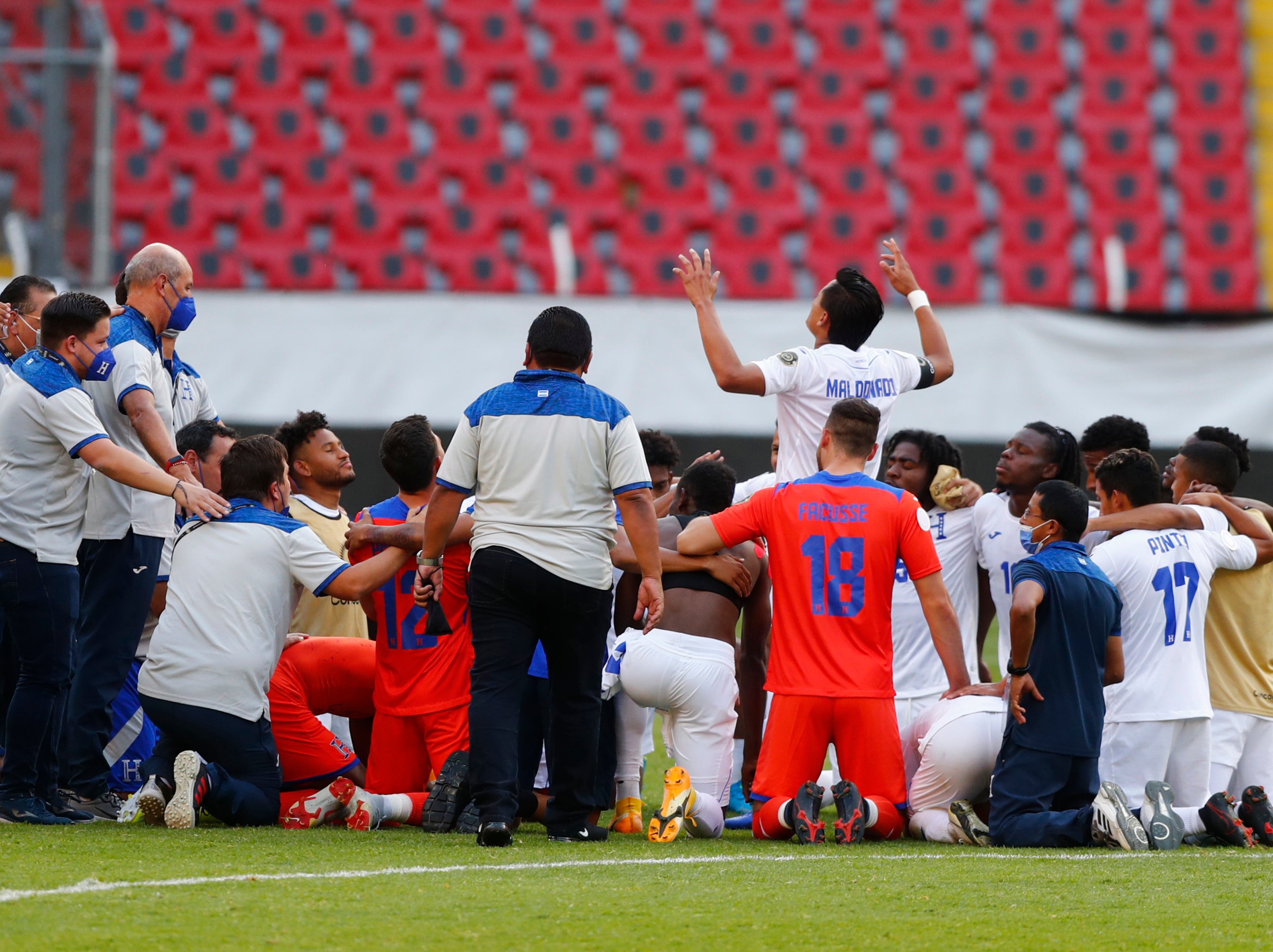 Honduras players and staff celebrate beating the United States