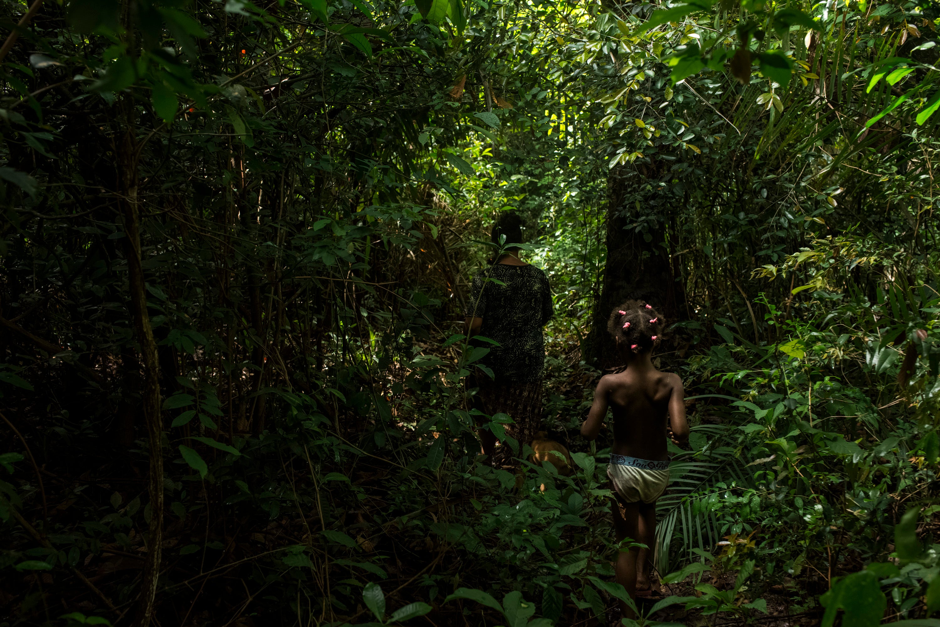 Pinheiro and her niece walk in the forests surrounding the local area