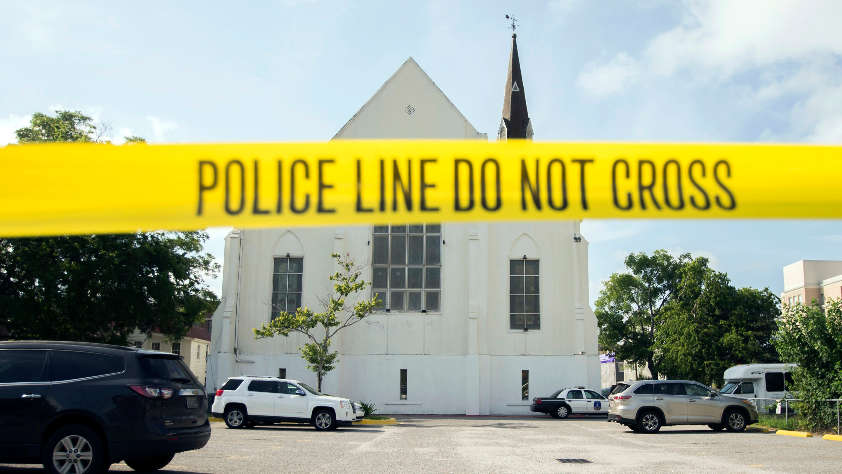 Police tape surrounds the parking lot behind the AME Emanuel Church as FBI forensic experts work the crime scene, in Charleston, Soth Carolina