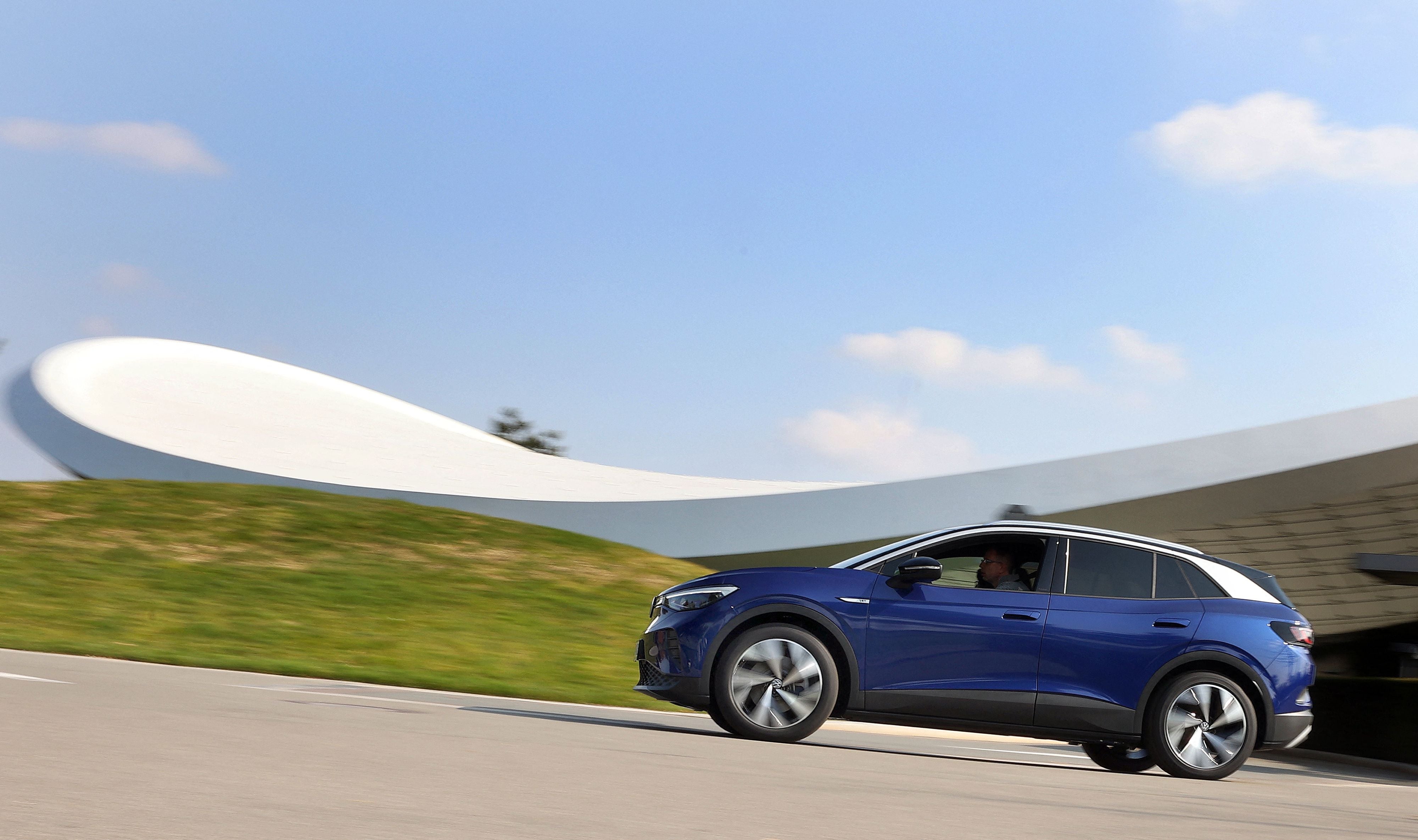 A new Volkswagen (VW) ID.4 SUV electric automobile leaves the customer centre of German carmaker Volkswagen in Wolfsburg, northern Germany on March 26, 2021.