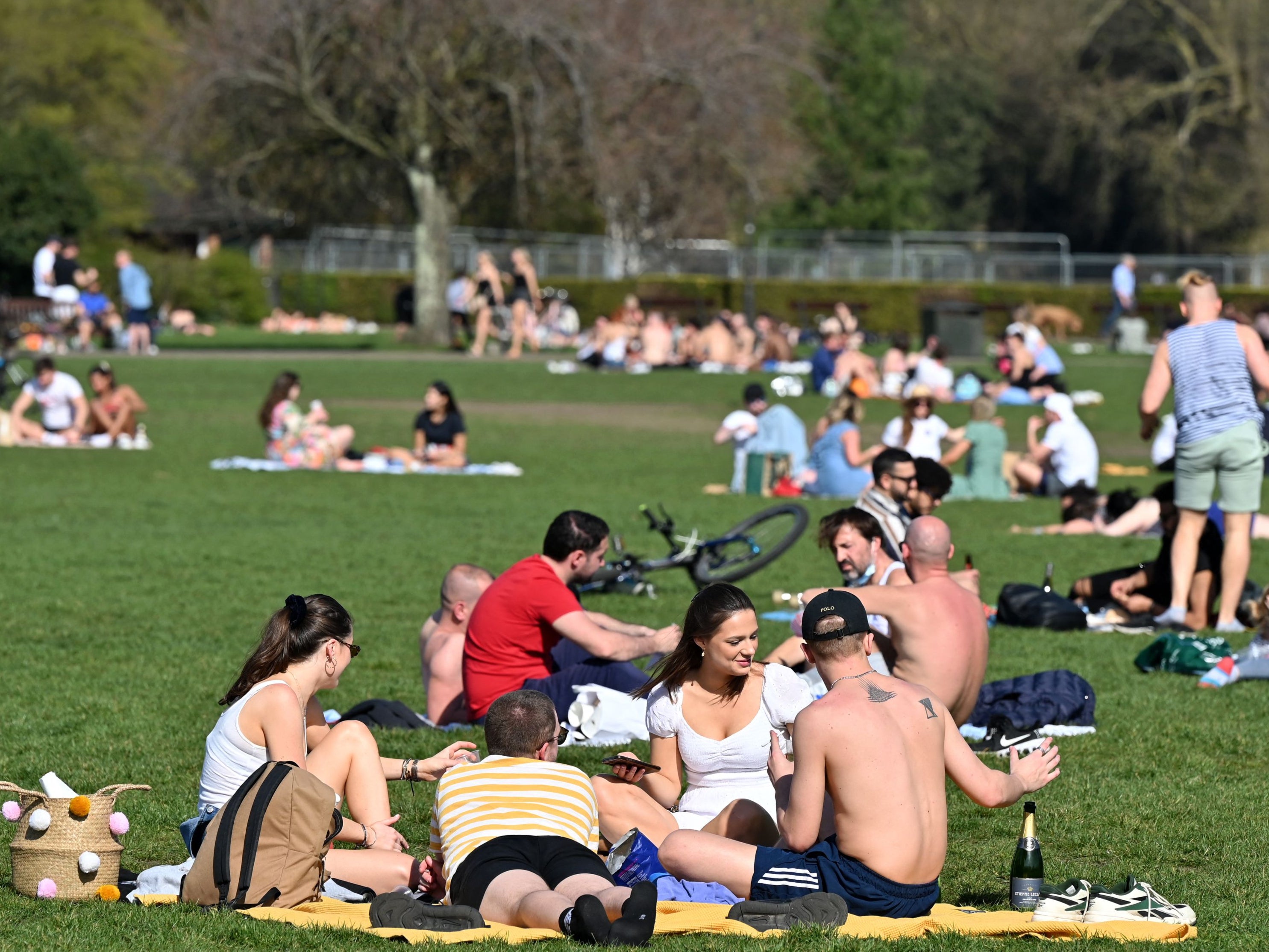 A group of friends open a bottle of fizz at Battersea Park